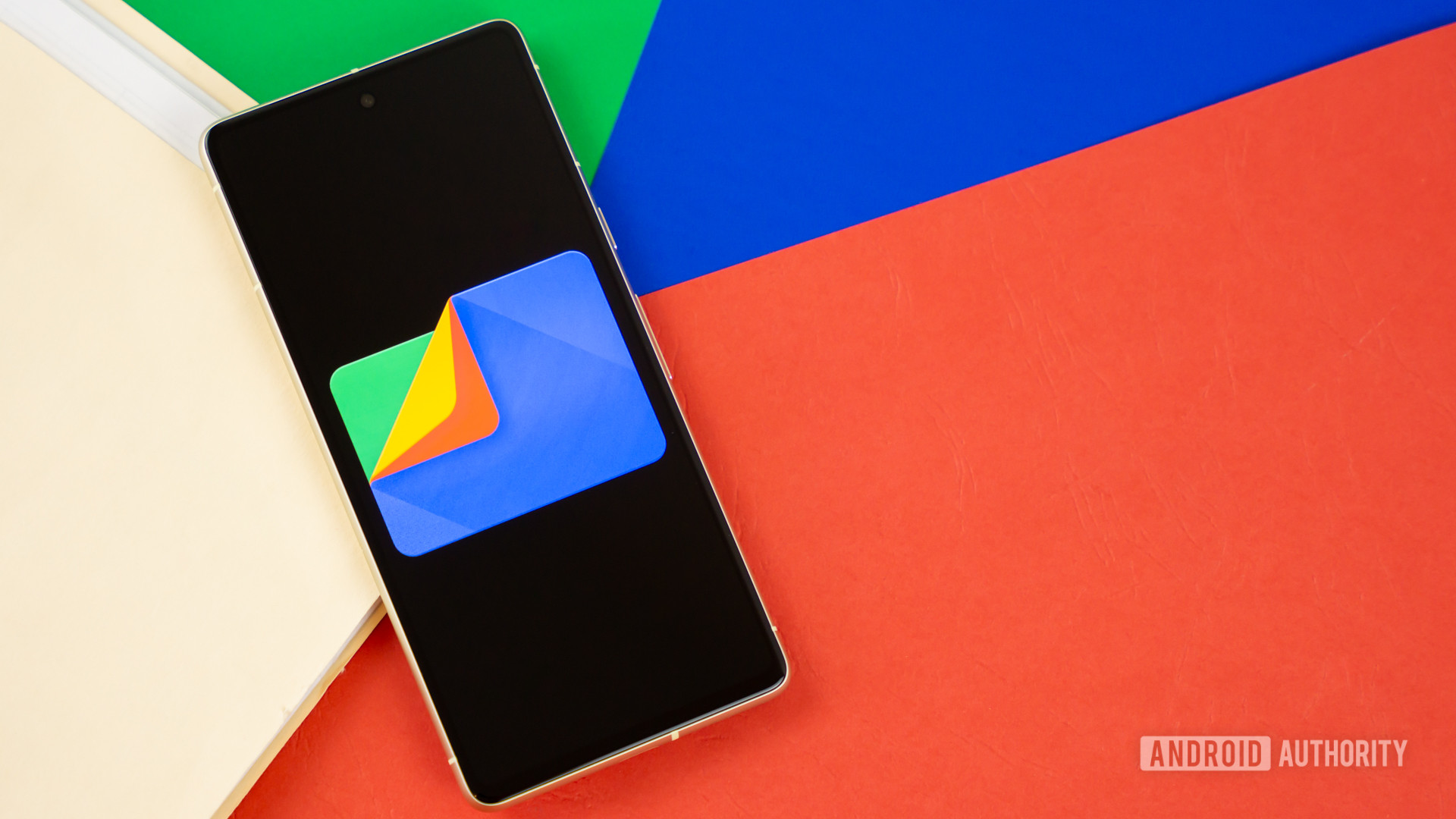 Google Files app logo on smartphone with manila folder and colorful background Stock photo 3