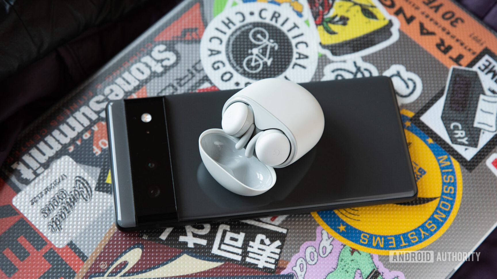 The Google Pixel Buds A-Series earbuds and case on a Pixel 6 phone.