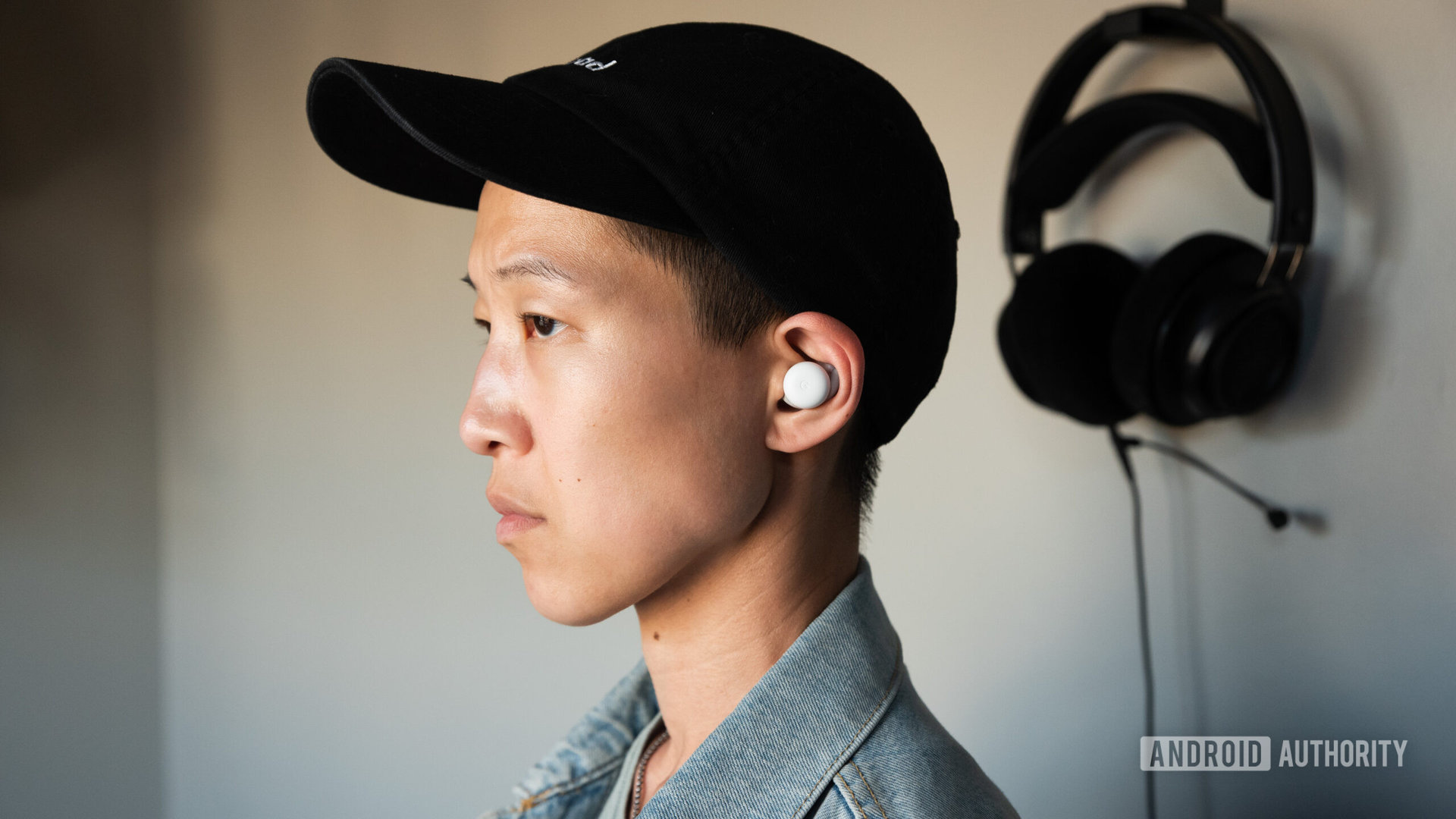 A person wears the Google Pixel Buds A-Series.