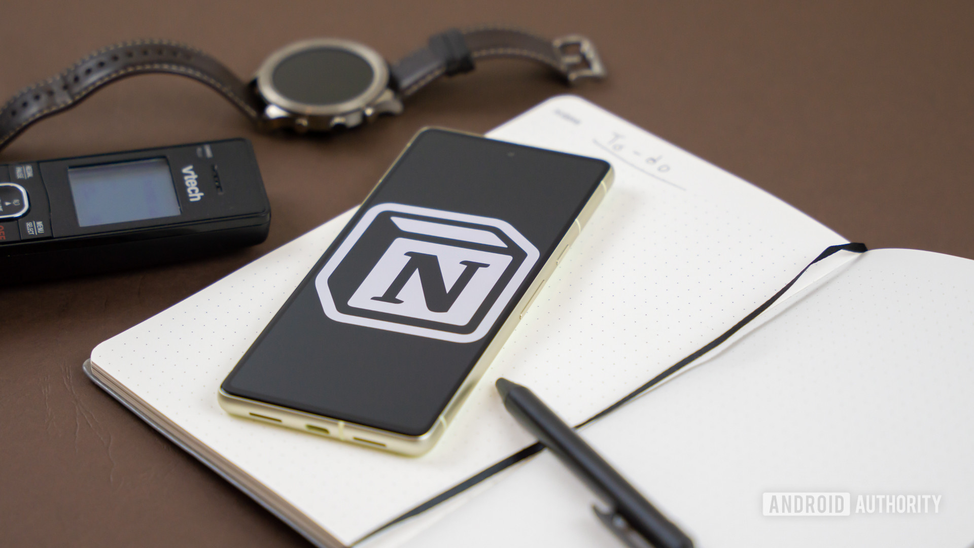 Notion logo on snartphone next to other office products Stock photo 1