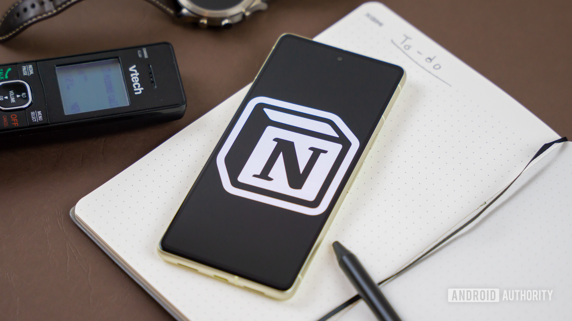 Notion logo on smartphone next to other office products Stock photo 2
