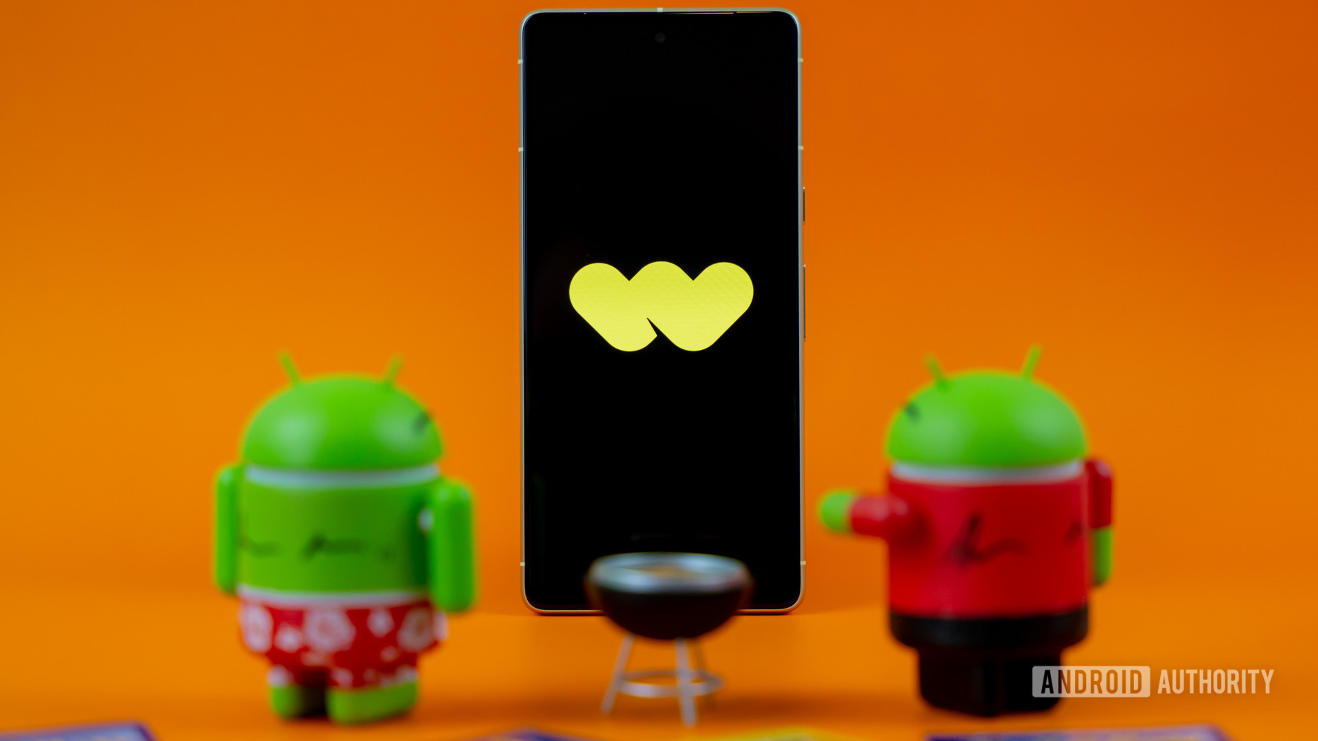 Whatnot logo on smartphone next to collectibles and toys Stock photo 4