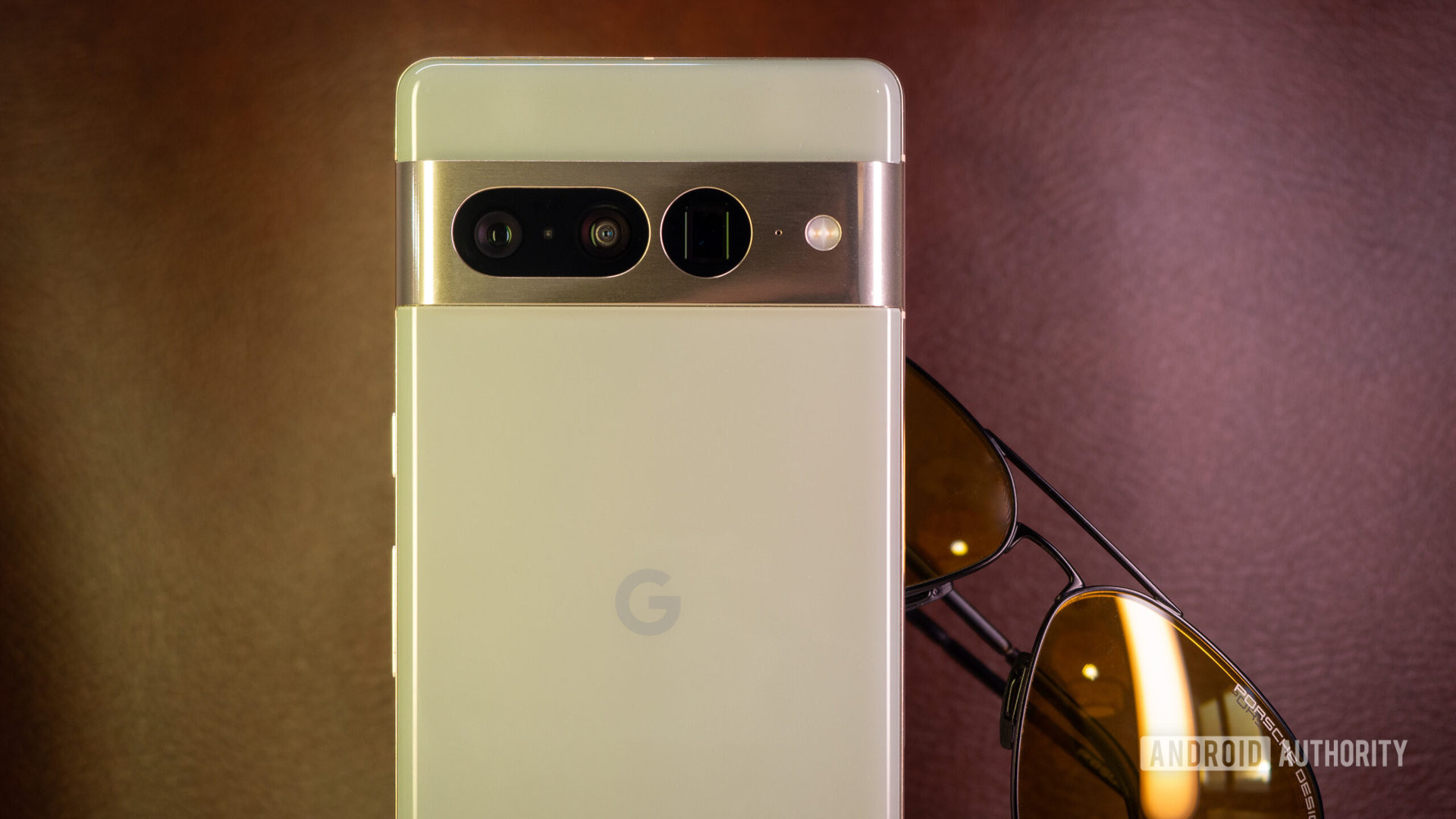 Google Pixel 7 Pro hazel on brown leather background with sunglasses
