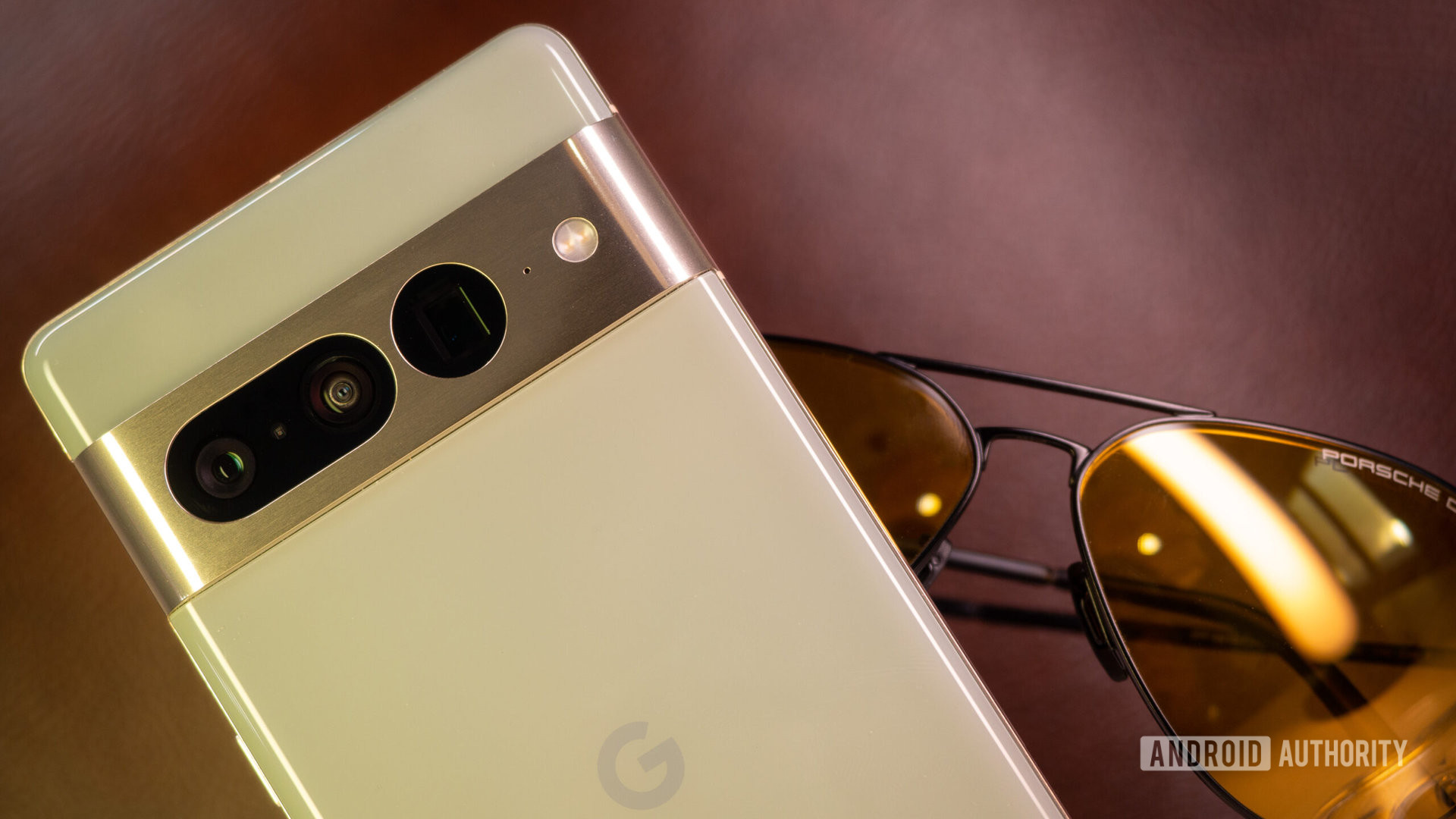 Google Pixel 7 Pro hazel on brown leather background with sunglasses