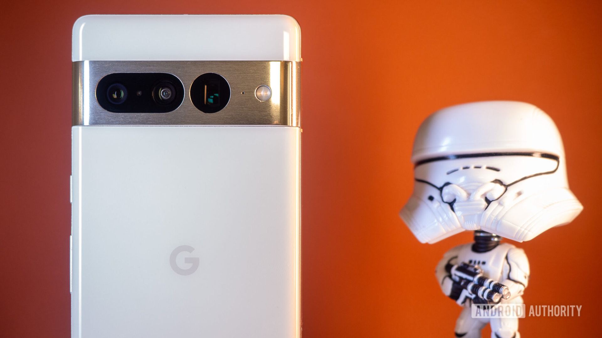 Google Pixel 7 Pro white next to stormtrooper figurine on orange background
