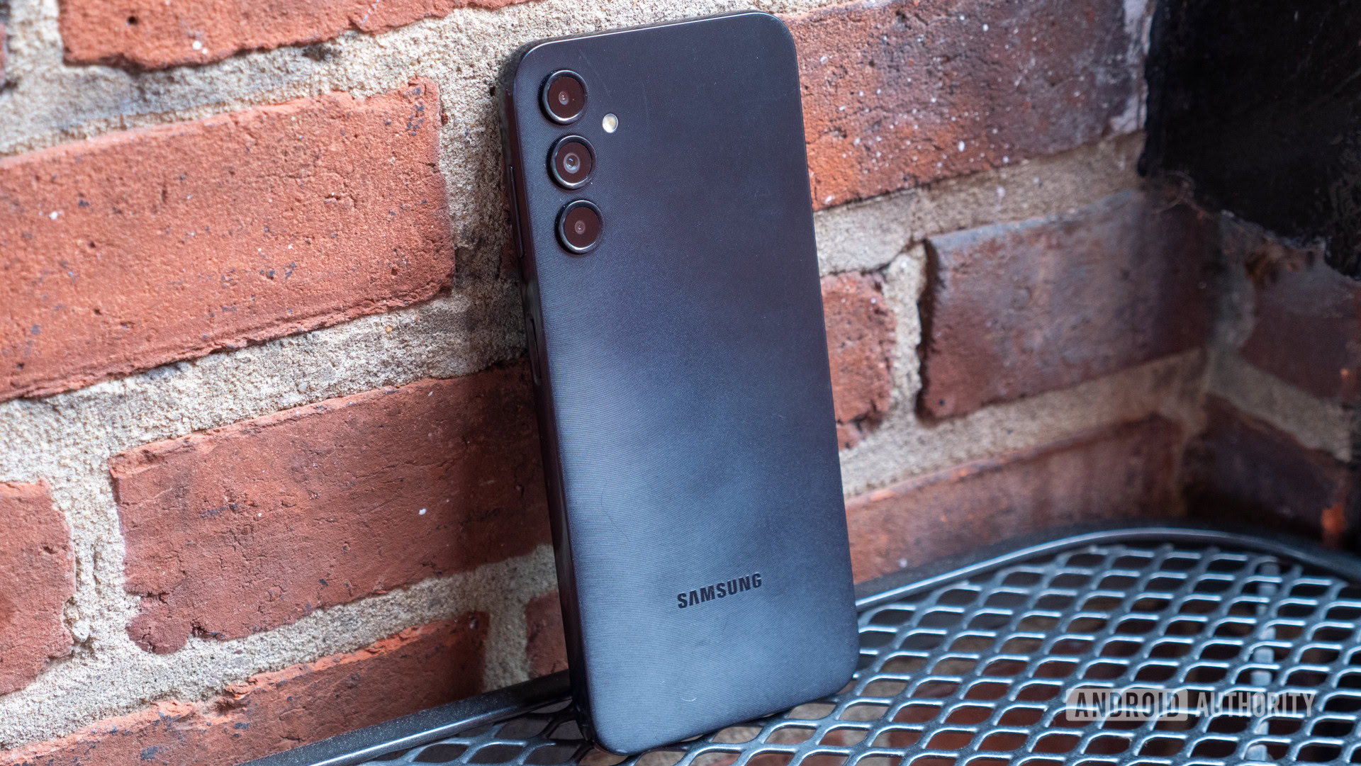 samsung galaxy a14 in front of bricks