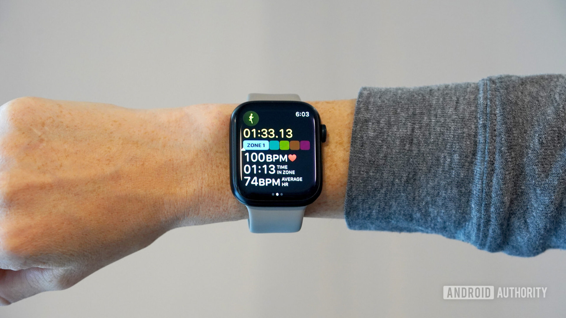An Apple Watch Series 8 on a user's wrist displays running metrics.
