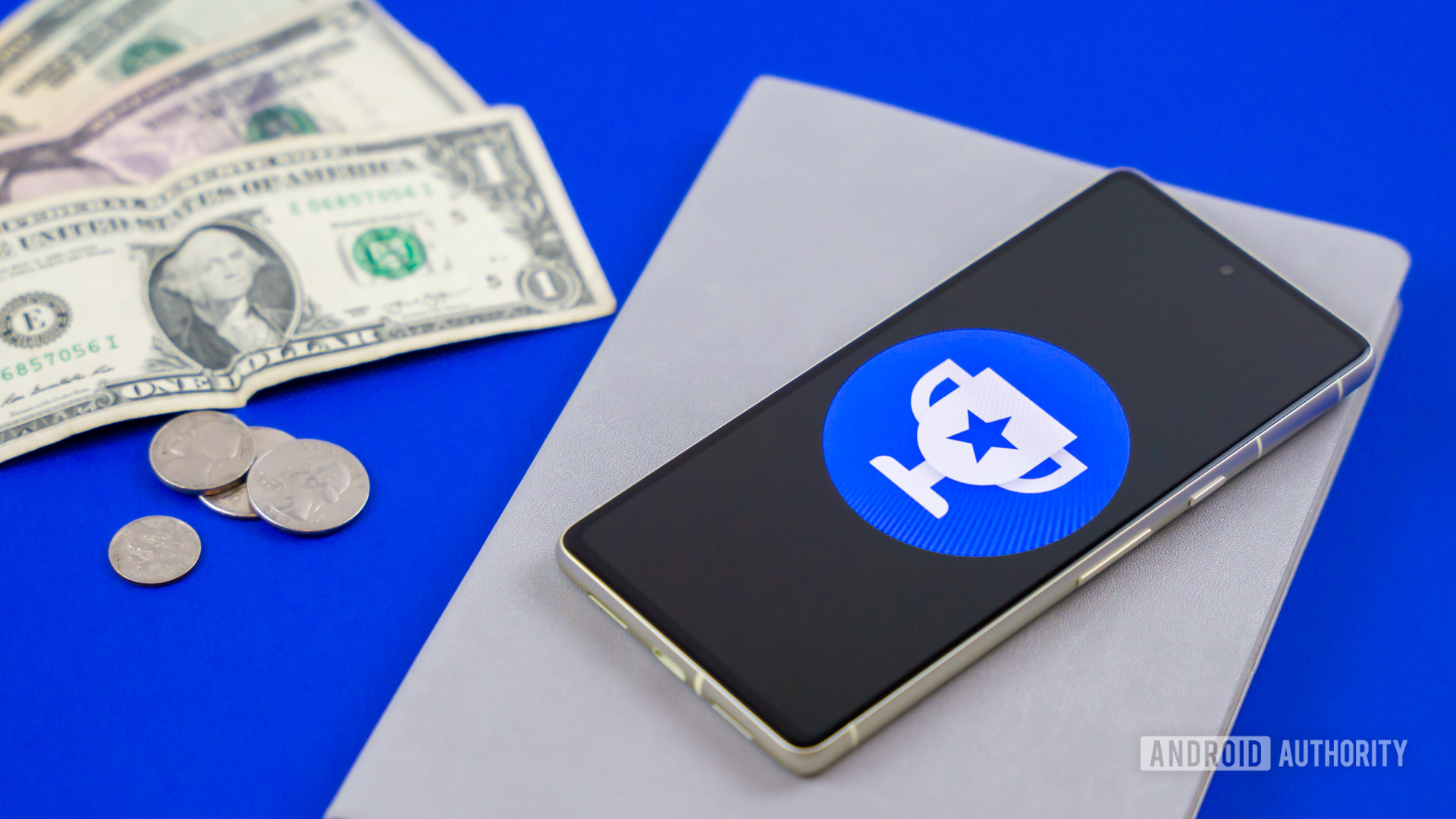 Google Opinion Rewards logo on smartphone next to money Stock photo 3