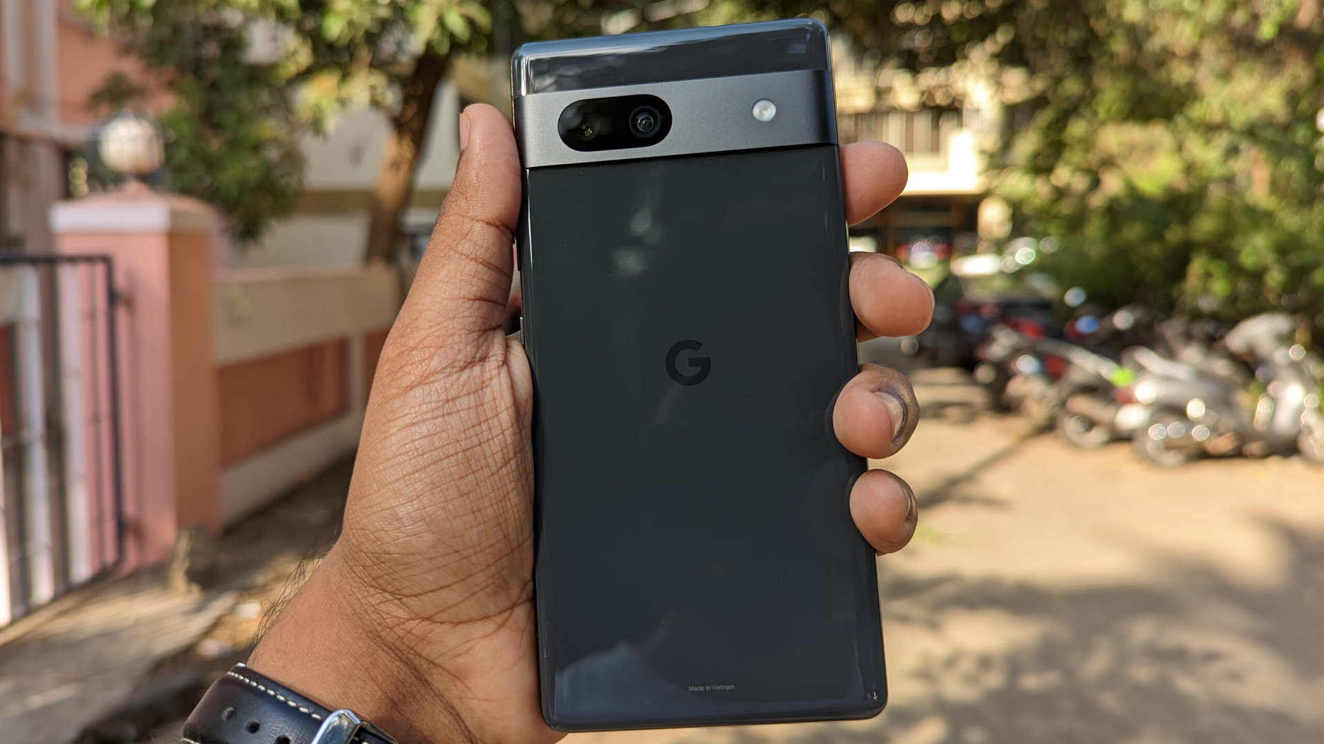 Google Pixel 7a in black held out in the hand