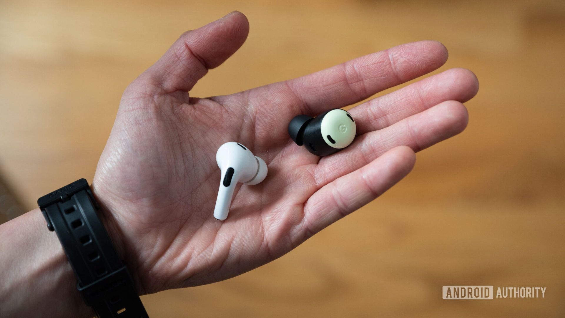 Google Pixel Buds Pro vs Apple AirPods Pro 2nd generation hand holds earbuds
