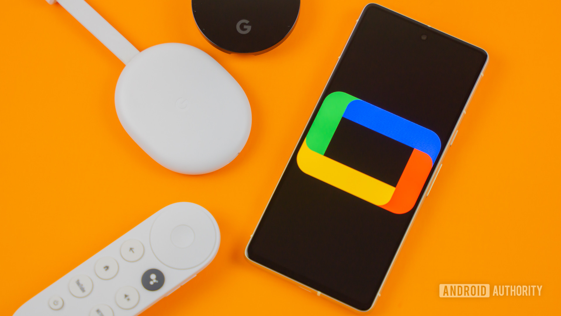 Google TV logo on smartphone next to Chromecast devices and remote Stock photo 3