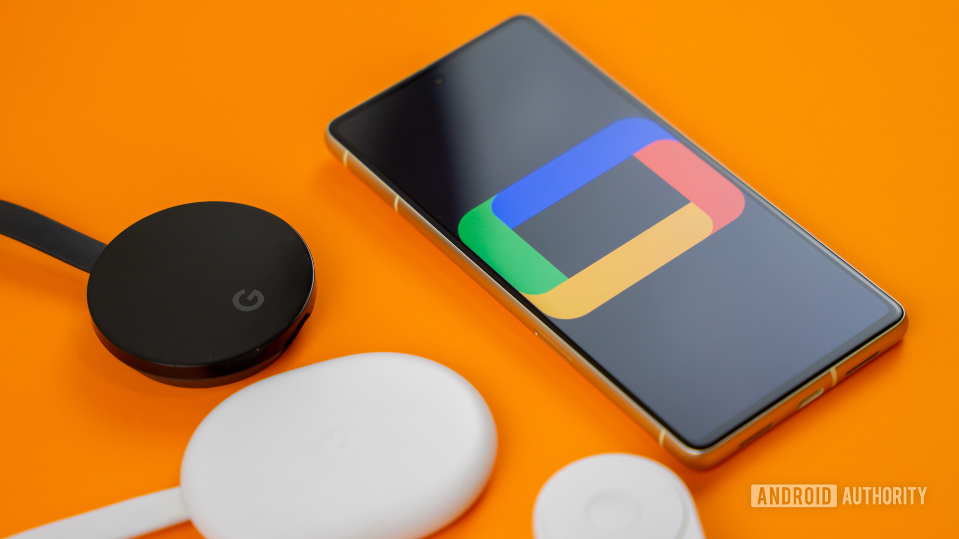 Google TV logo on smartphone next to Chromecast devices and remote Stock photo 4