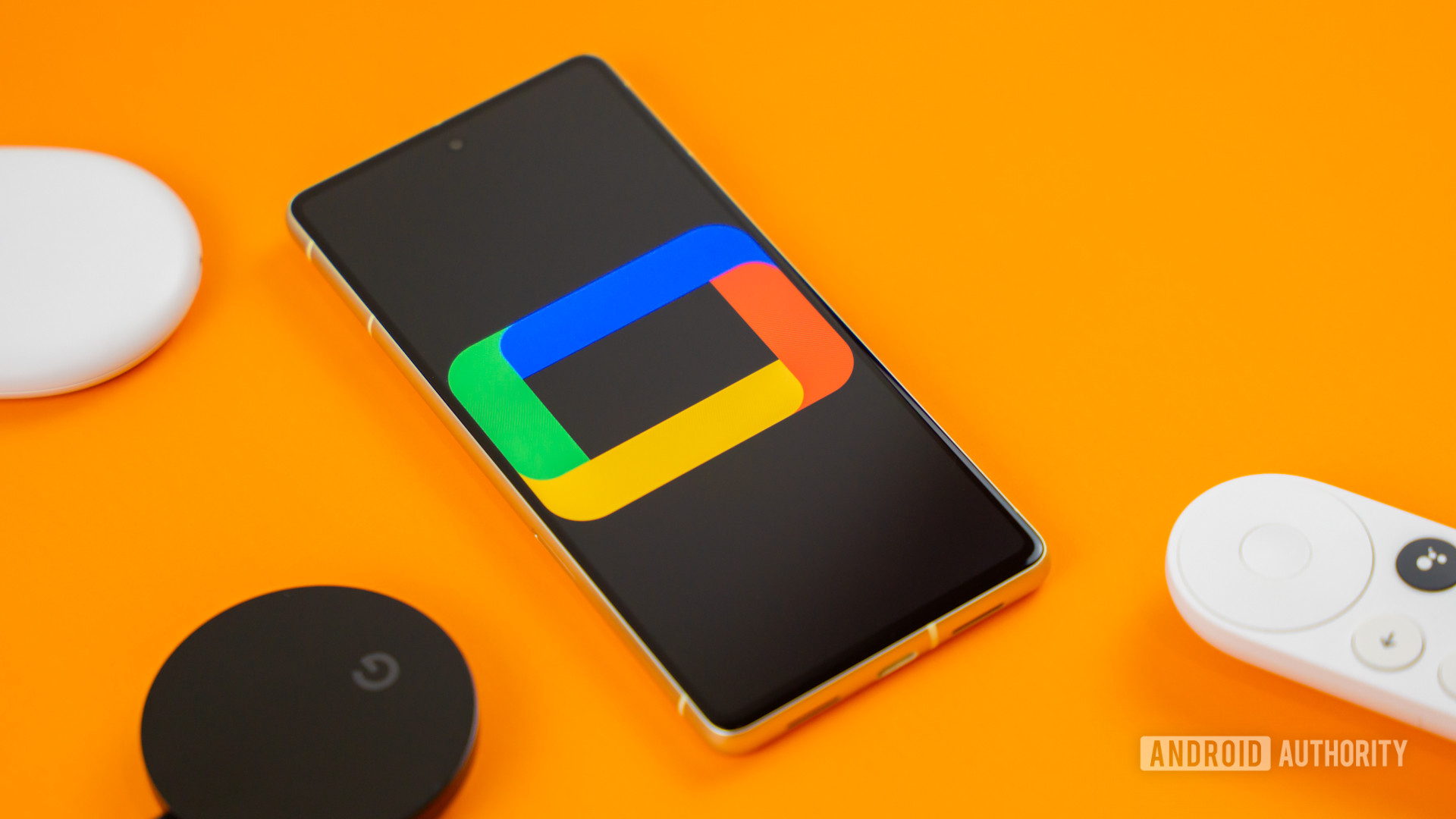 Google TV logo on smartphone next to Chromecast devices and remote Stock photo 5