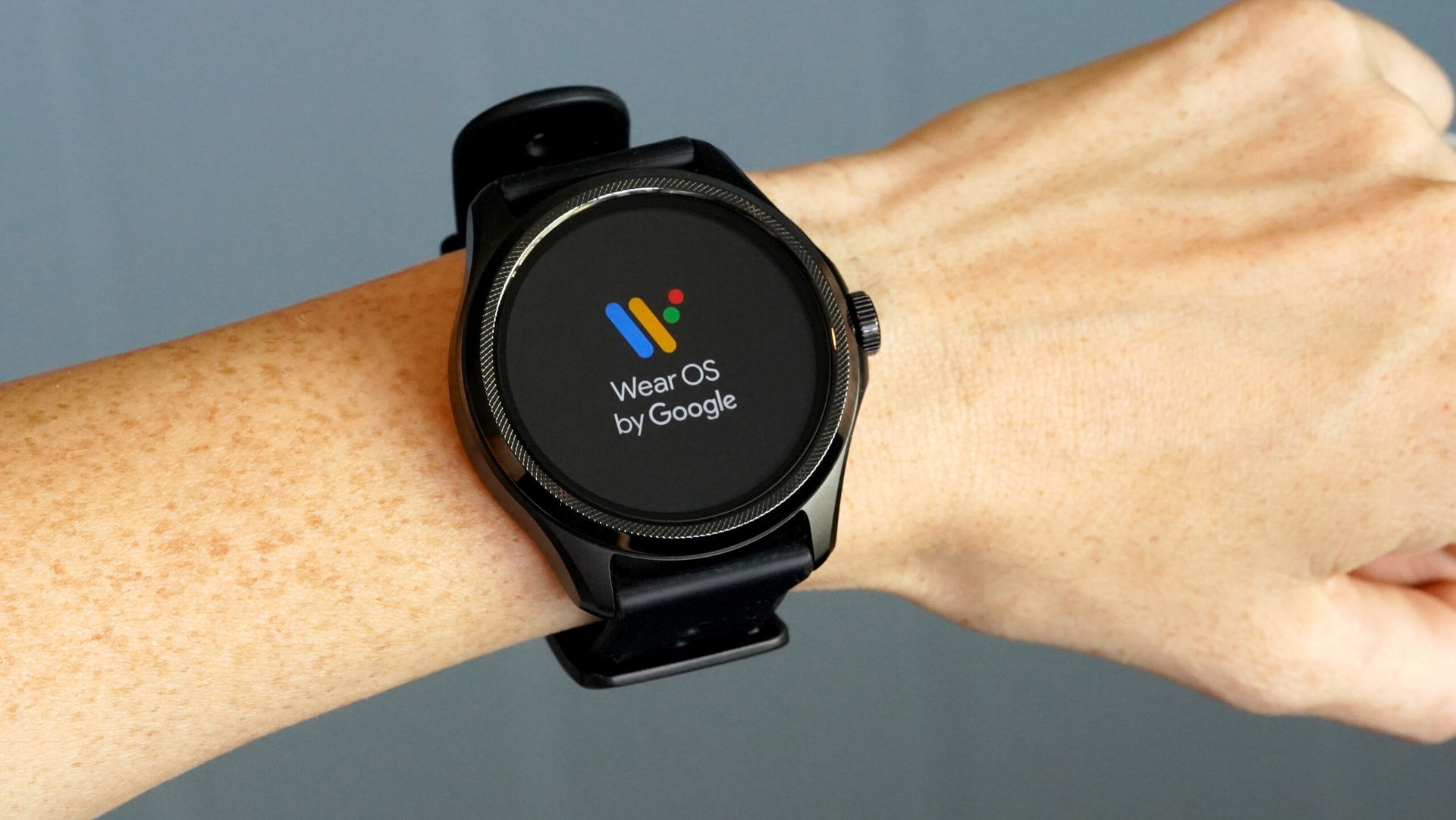A Mobvoi TicWatch Pro 5 displays the Wear OS start screen.