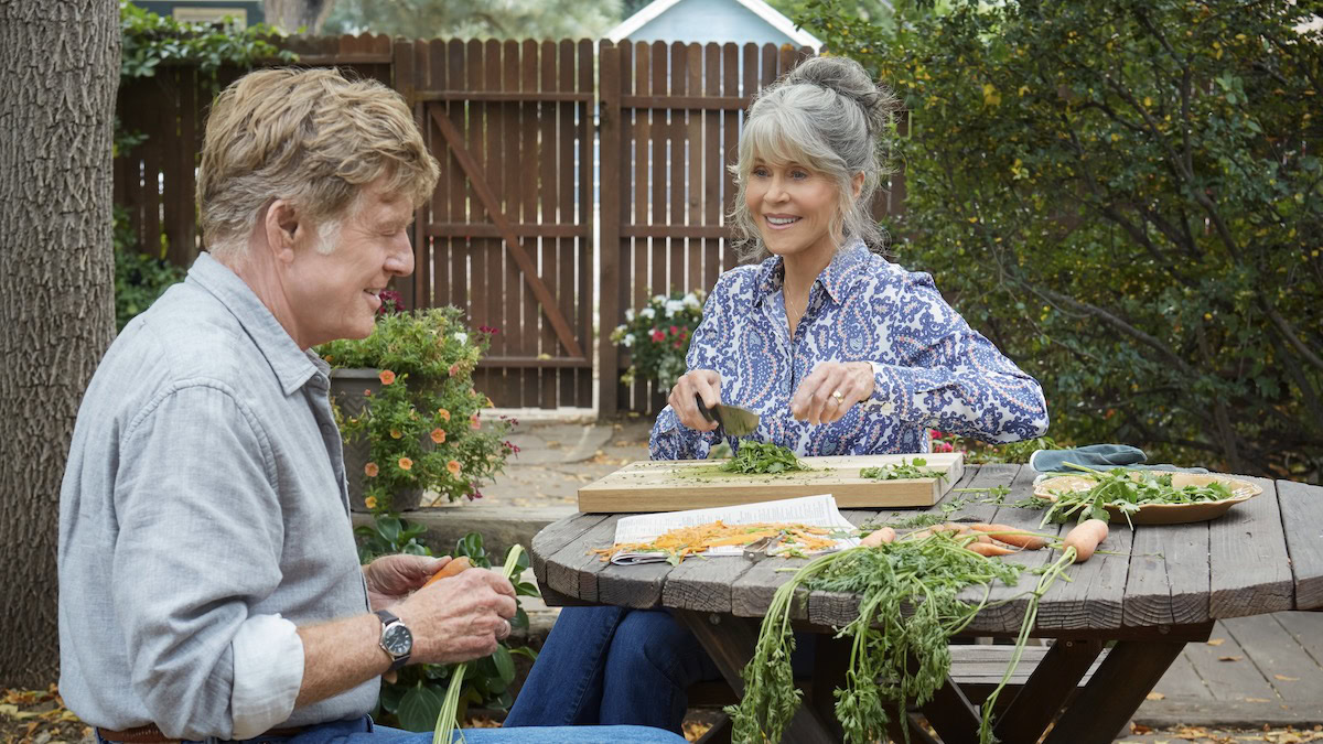 Robert Redford and Jane Fonda cutting vegetables together outdoors in Our Souls at Night - best romantic movies on Netflix