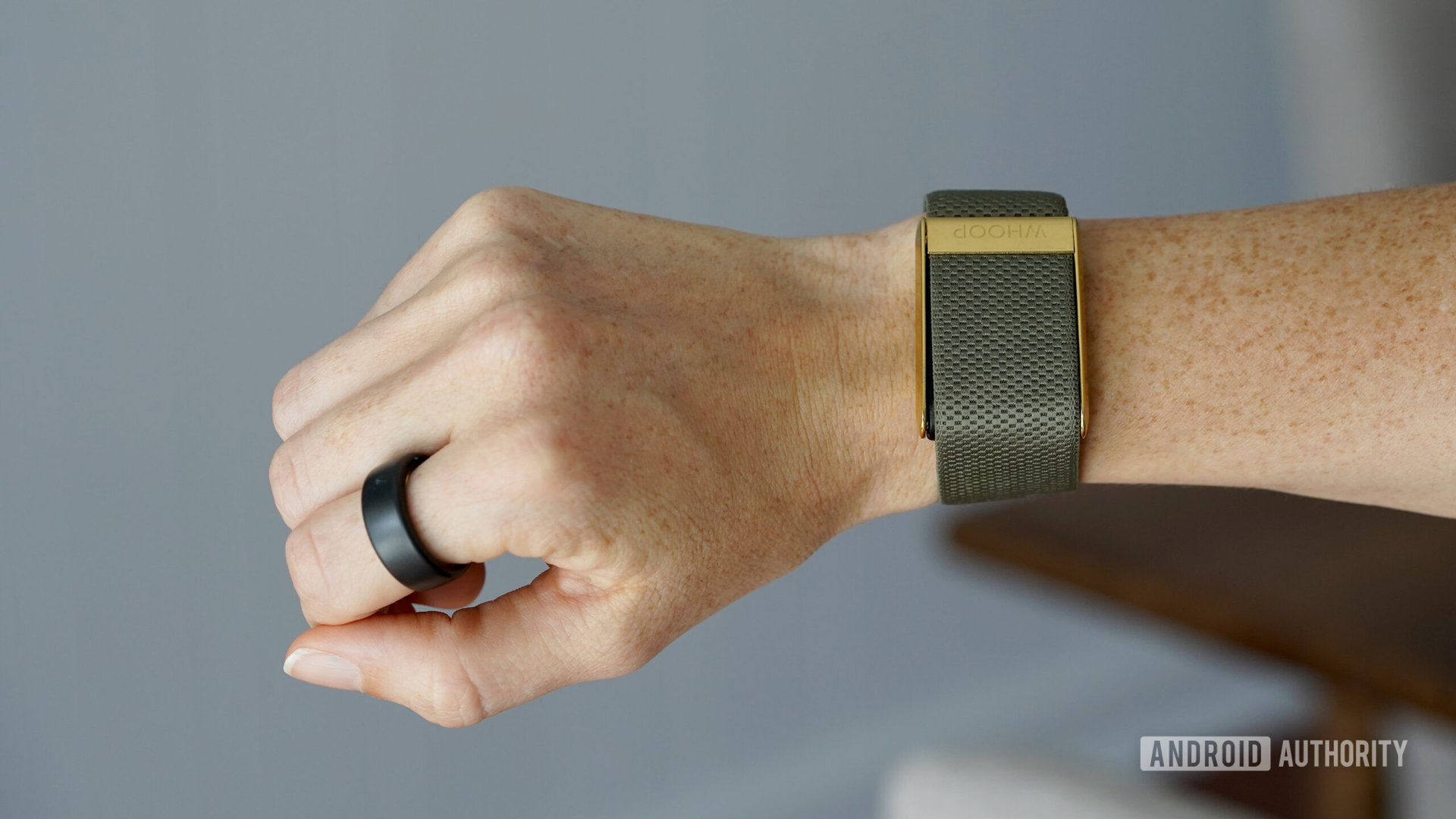 An user's arm models an Oura Ring 3 and Whoop 4.0.