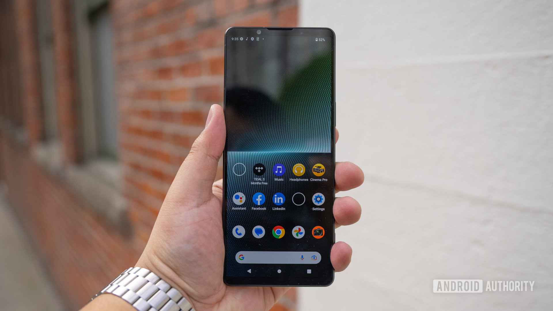 Sony Xperia 1 V in hand brick background