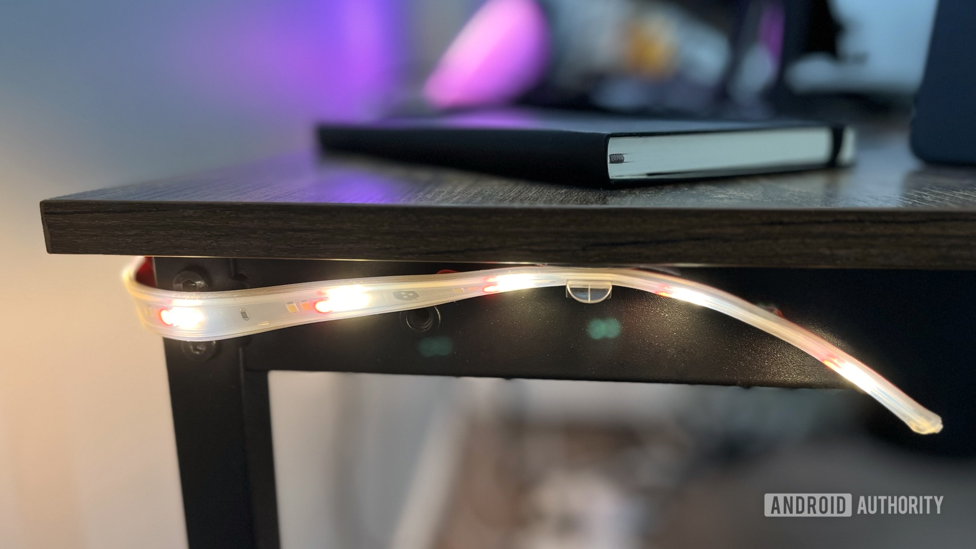 The Nanoleaf Matter Lightstrip hooked on a desk