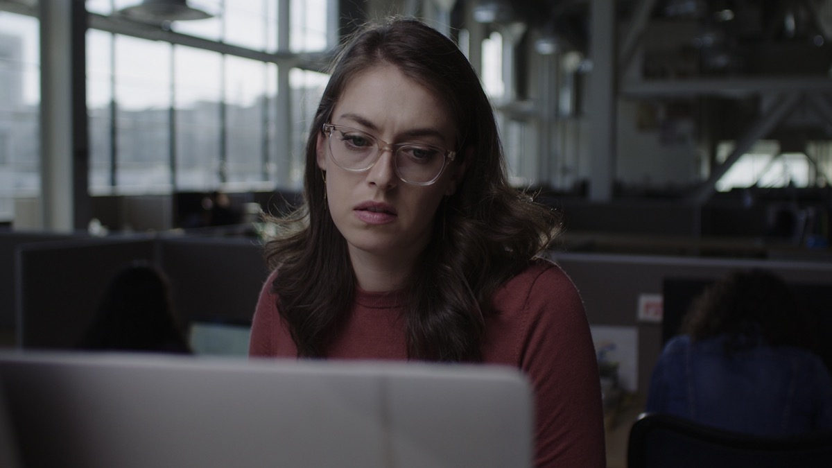 Rae deLeon looks at a laptop screen in Victim Suspect - best new streaming movies