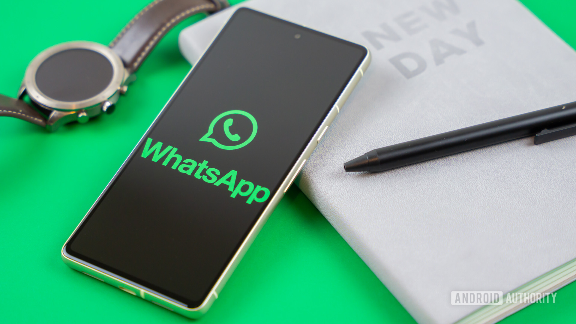 WhatsApp logo on smartphone next to everyday accessories Stock photo 1