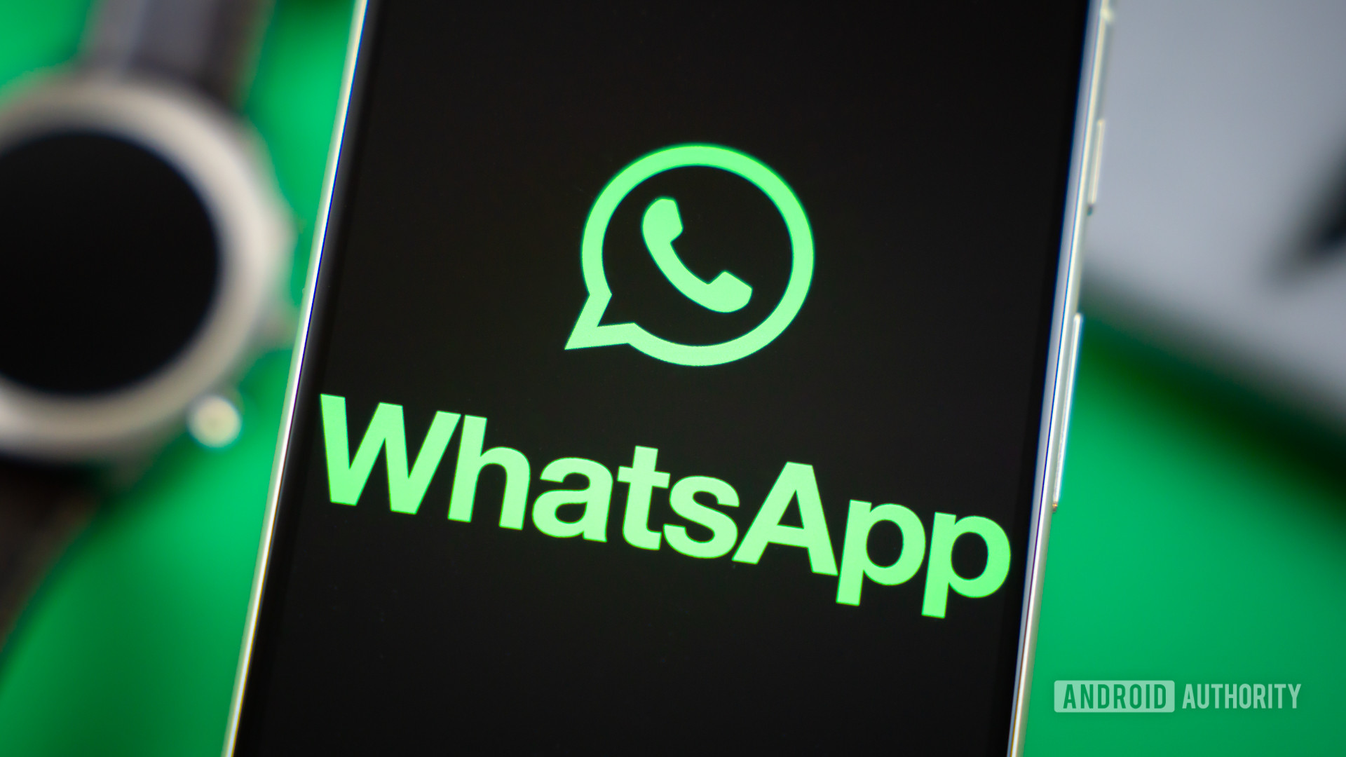 WhatsApp logo on smartphone next to everyday accessories Stock photo 3