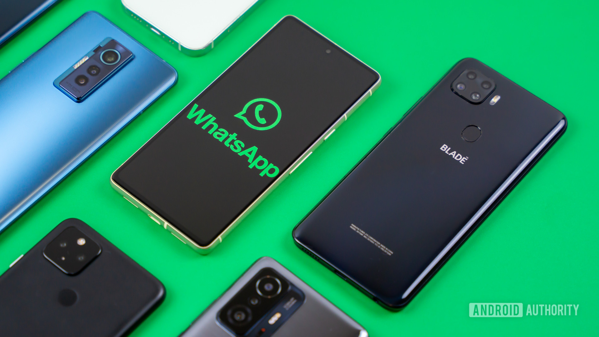 WhatsApp logo on smartphone next to other devices Stock photo 2