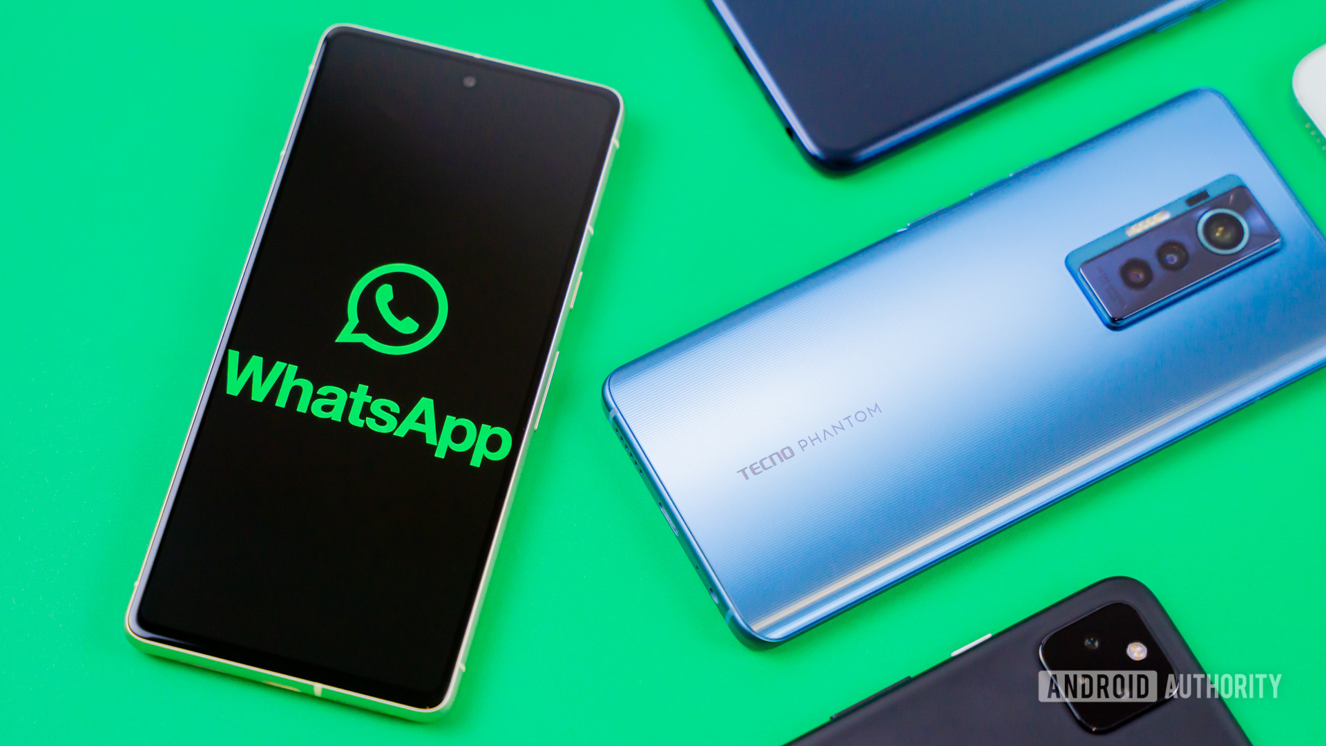 WhatsApp logo on smartphone next to other devices Stock photo 4