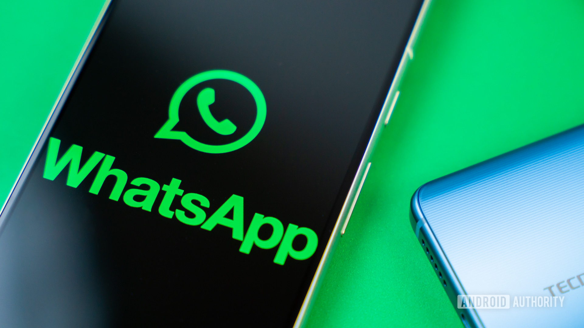 WhatsApp logo on smartphone next to other devices Stock photo 5