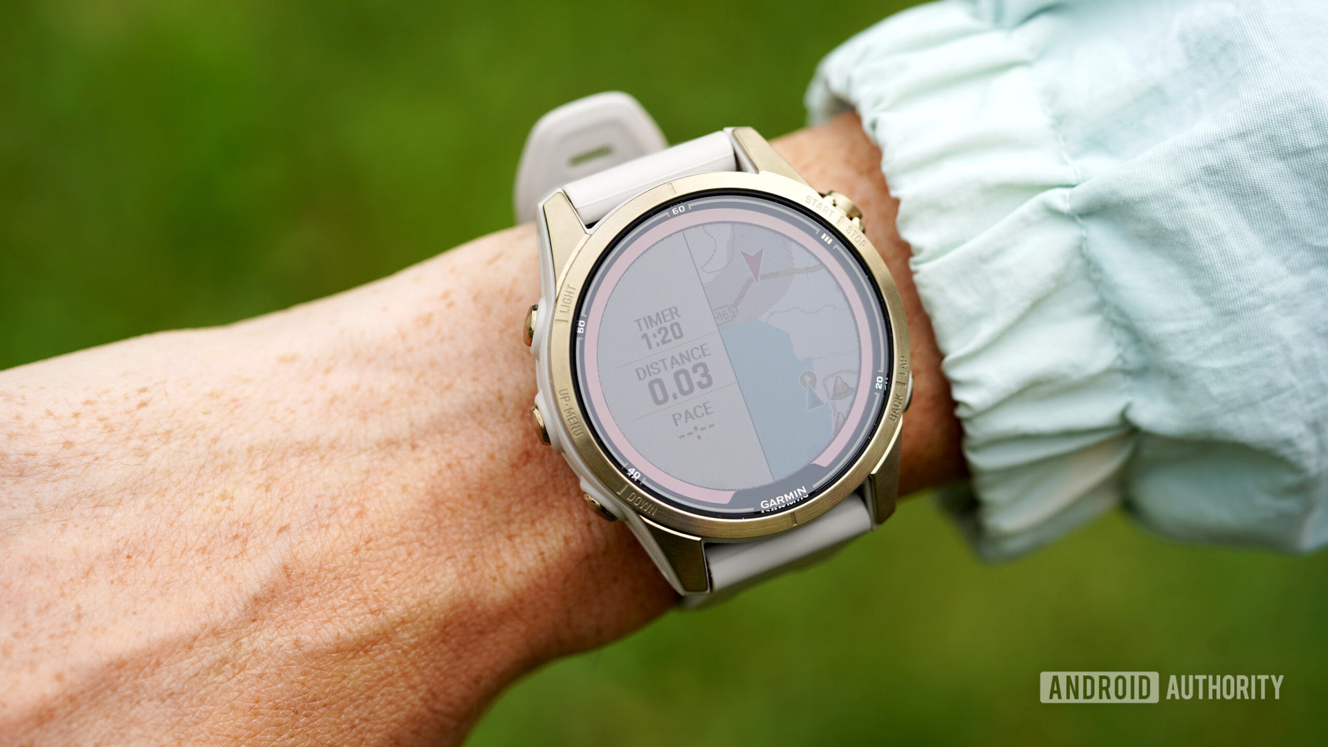 A Garmin watch displays split screen maps