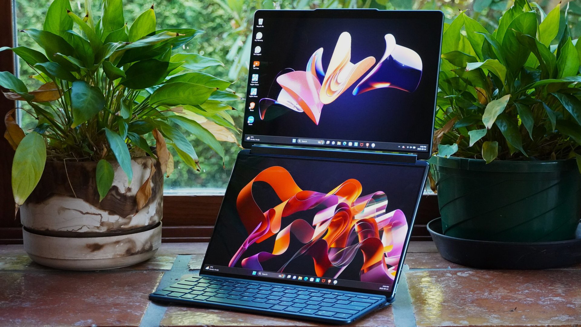 Lenovo Yoga Book 9i standign with plants