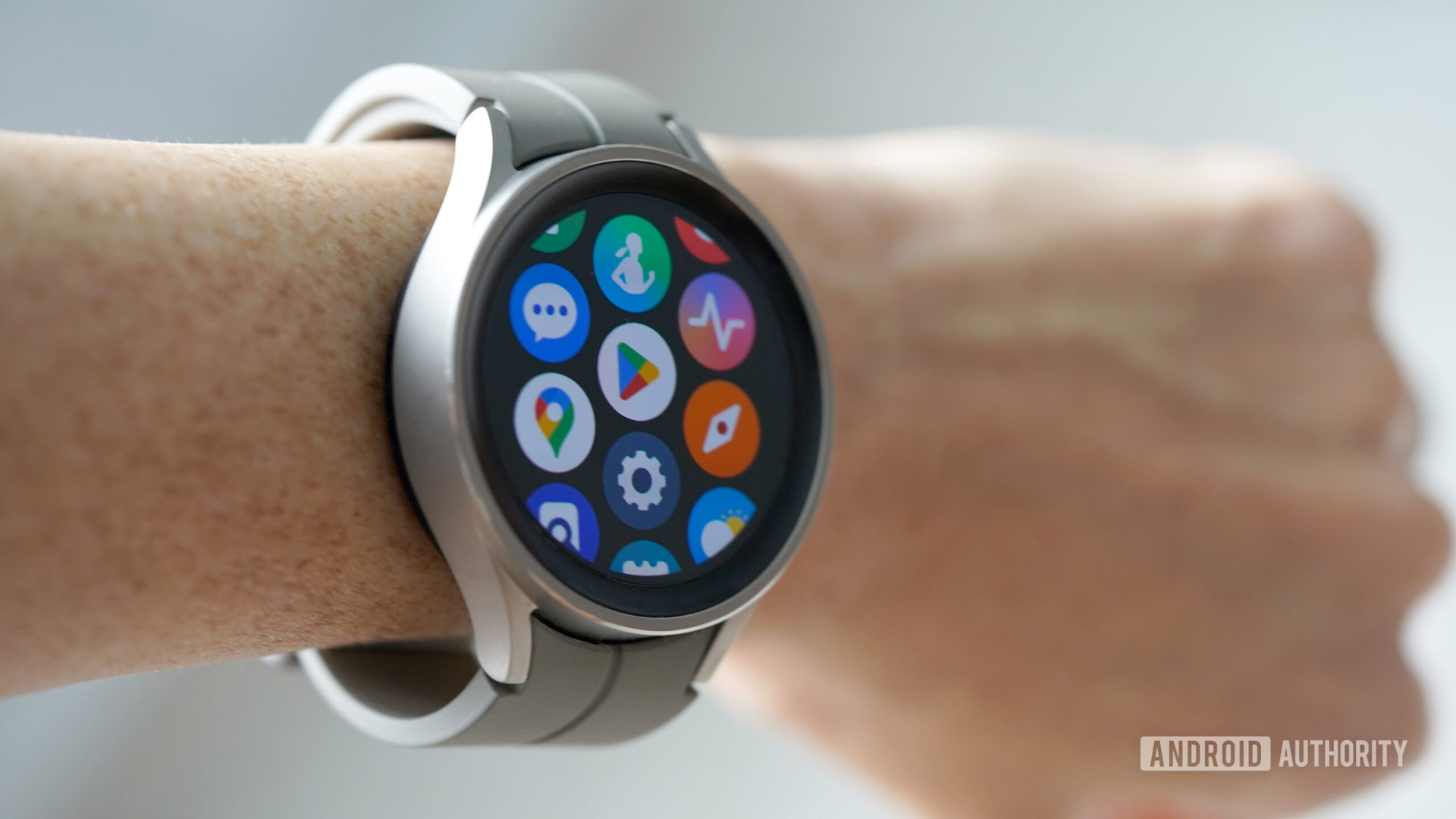 A Samsung Galaxy Watch 5 Pro on a user's wrist displays the app screen.