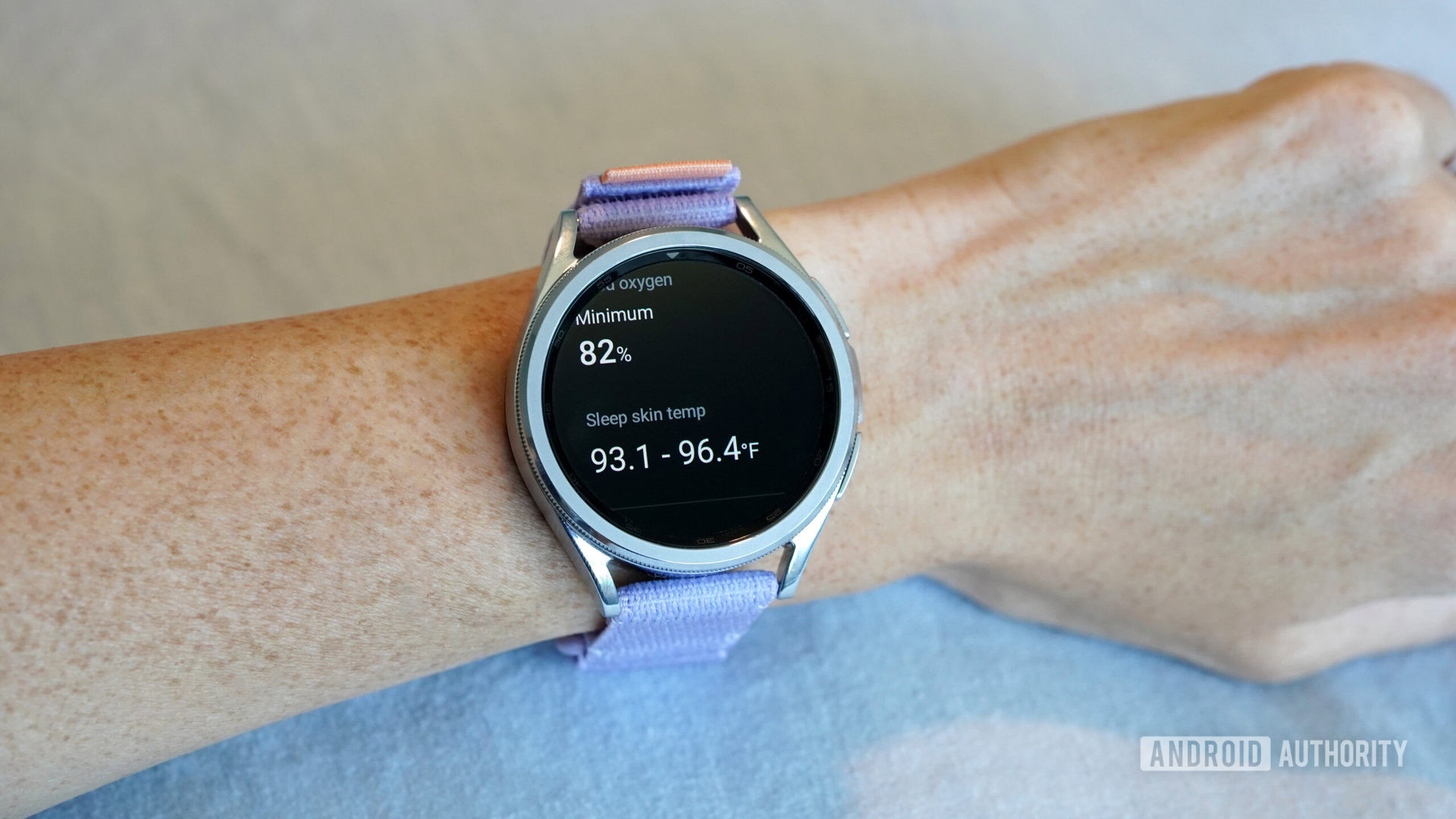 A Galaxy Watch displays a user's overnight blood oxygen and skin temperature data.