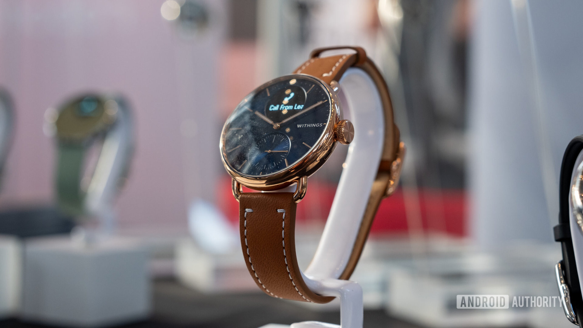 Withings Scanwatch 2 on a watch stand with brown leather strap