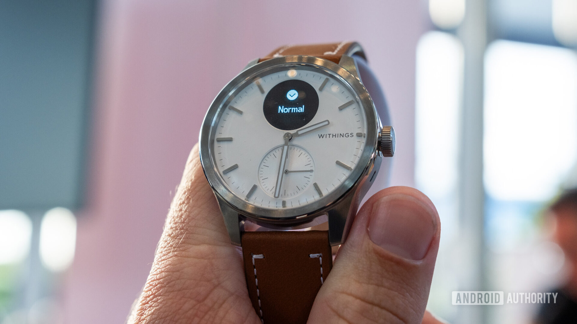 Withings Scanwatch 2 with brown leather strap in hand