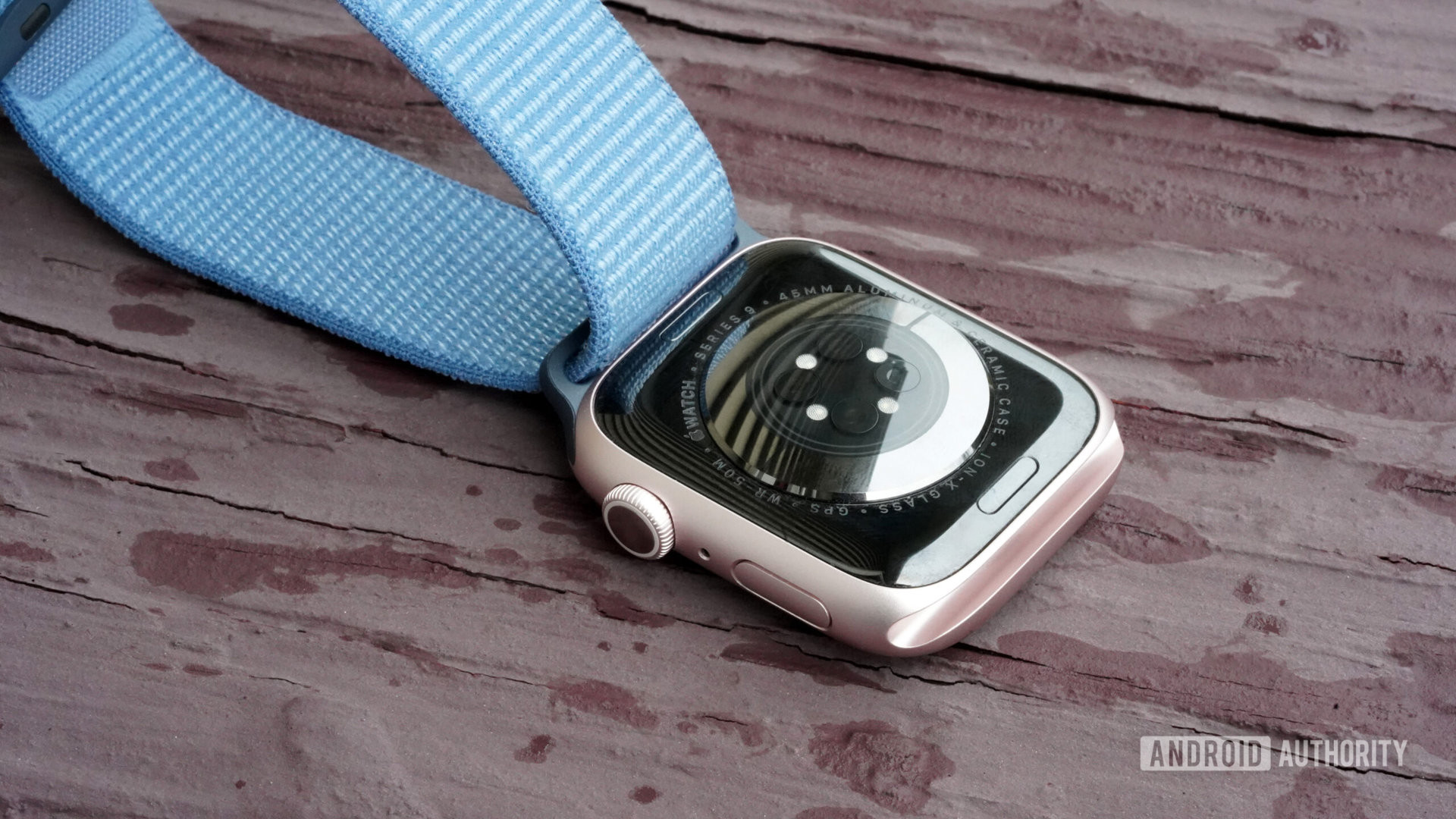 An Apple Watch Series 9 rests face down displaying the device's sensors.