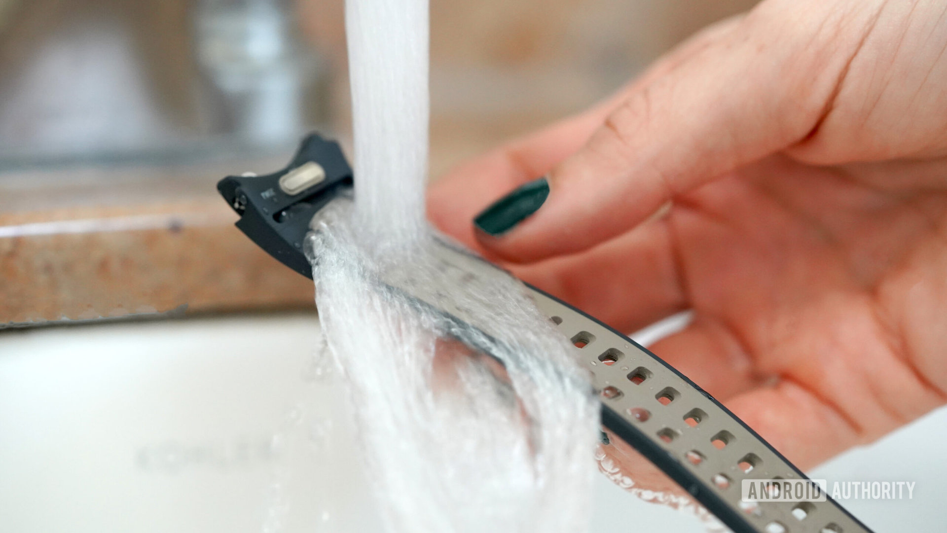 A user washes their silicone smartwatch band.