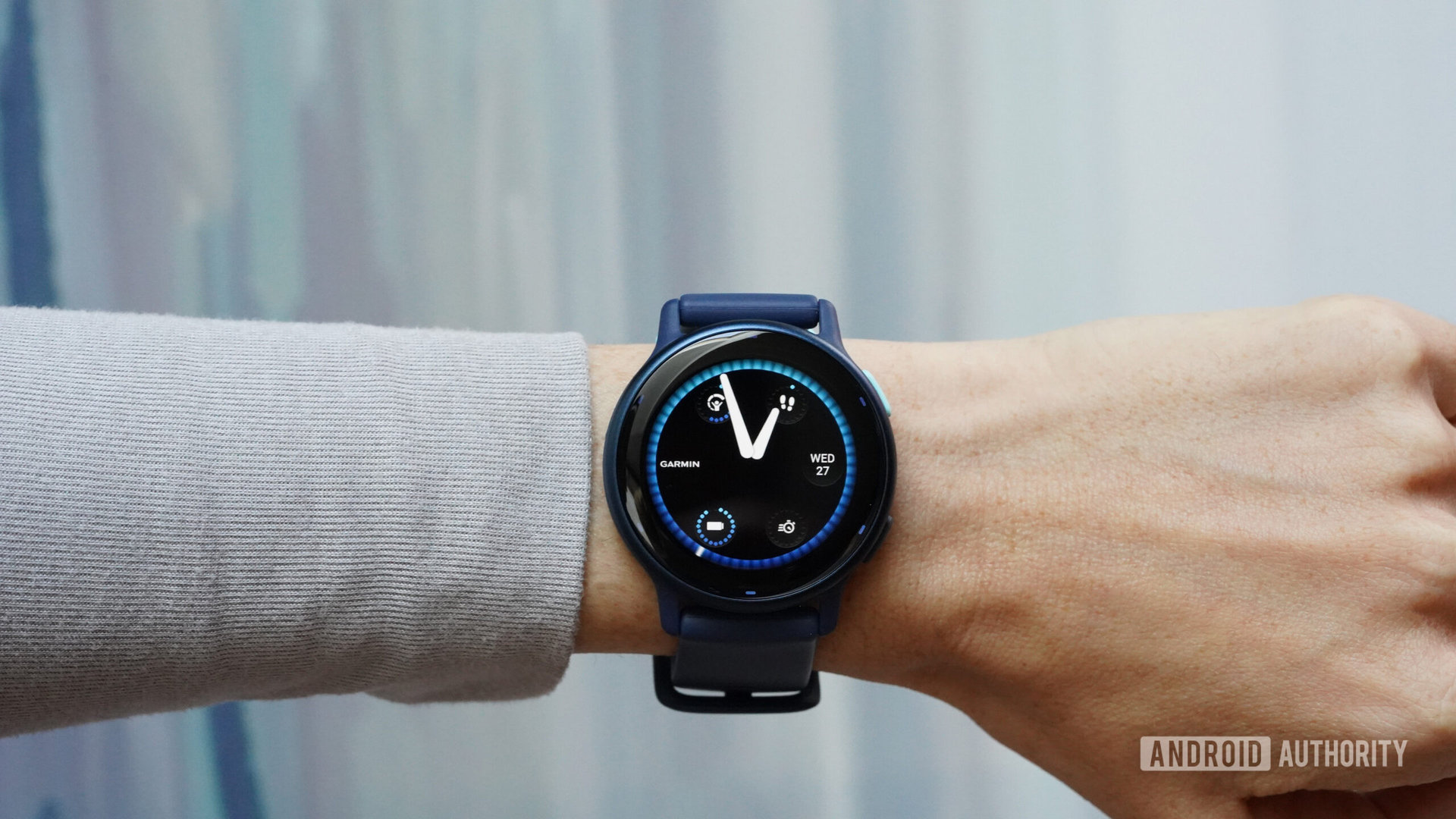 A Garmin Vivoactive 5 on a user's wrist displays its watch face.