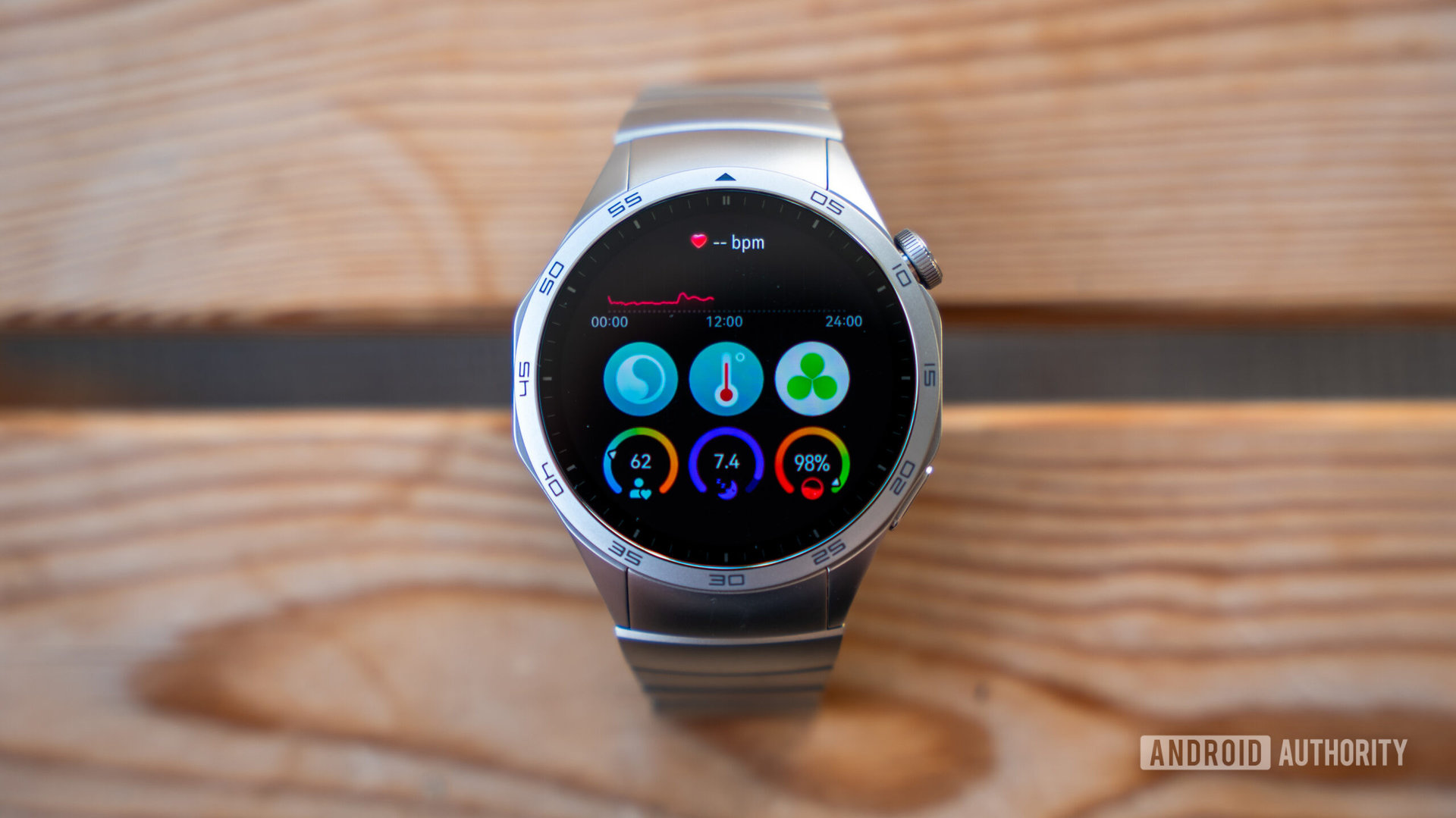 Huawei Watch GT 4 smartwatch on table showing health tracker dashboard screen