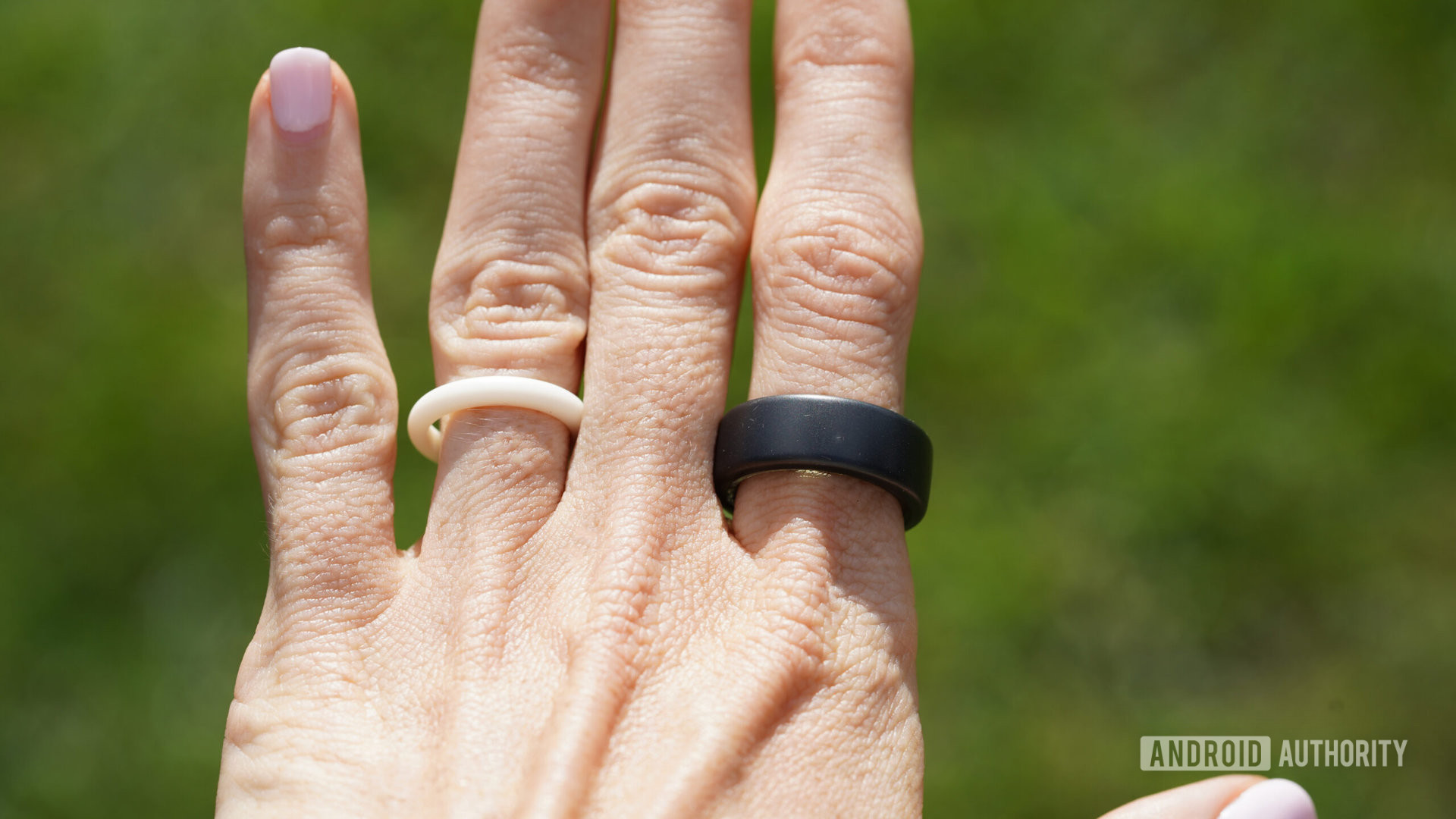 An Oura Ring 3 on a users hand shows wear.