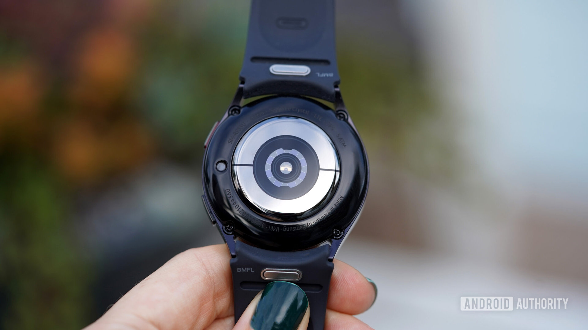 A Samsung Galaxy Watch 6 face down displays its sensor package.