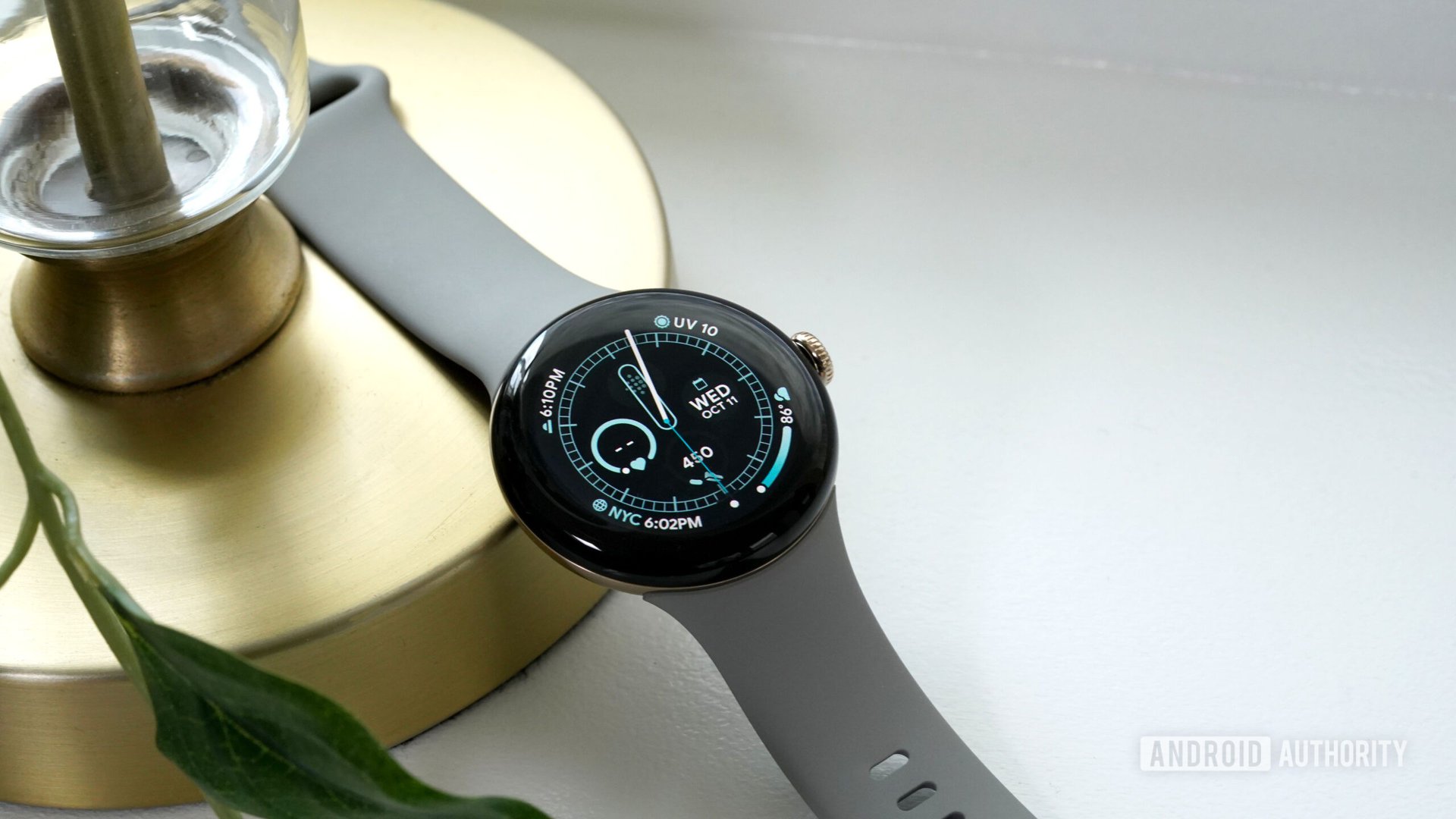 A Google Pixel Watch 2 displays the watch face.