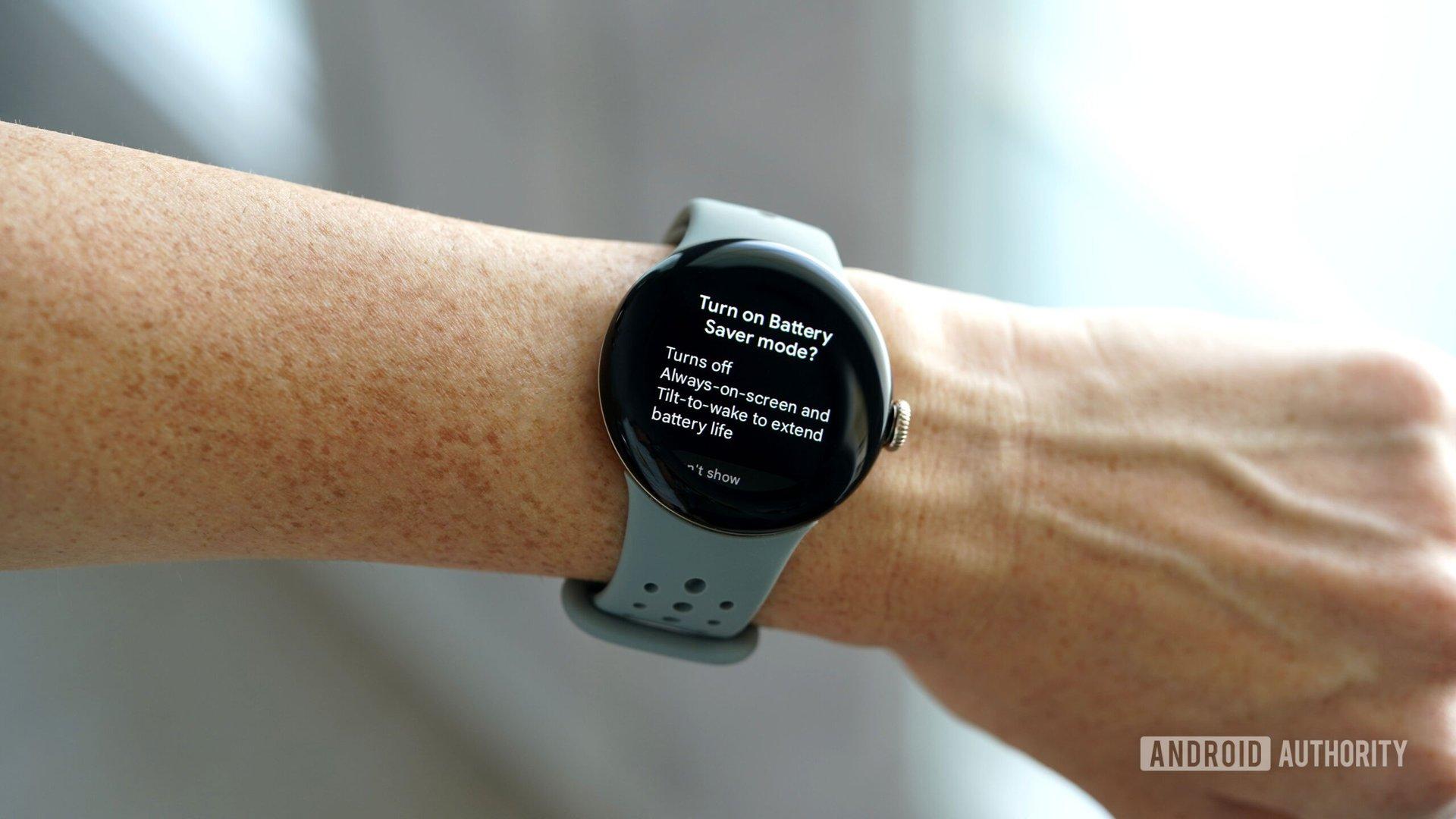 A Google Pixel Watch 2 displays battery saver mode.