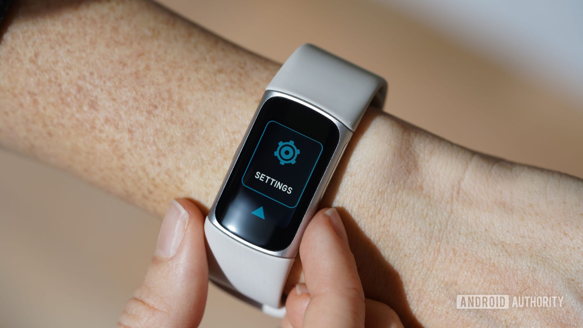 A user accesses the Settings menu on their Fitbit Charge 6.