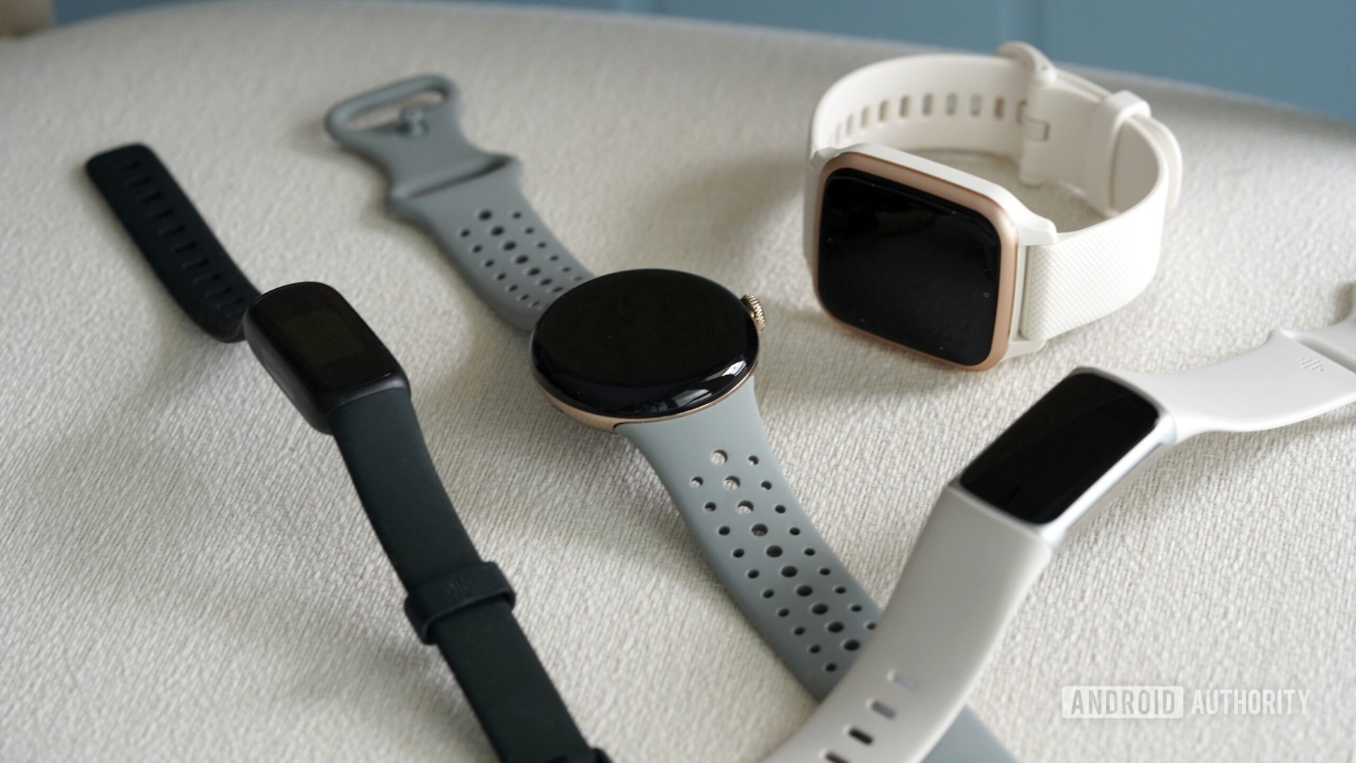 A Fitbit Charge 6 rests among alternative wearables.