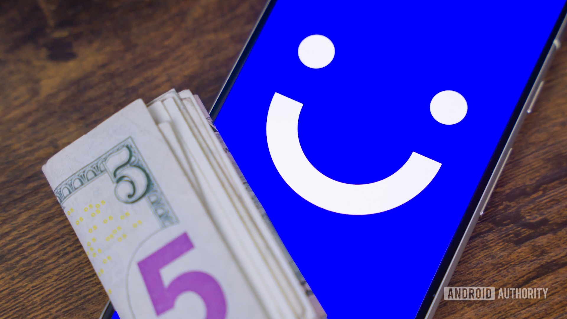 Visible logo on smartphone, next to money, stock photo (2)