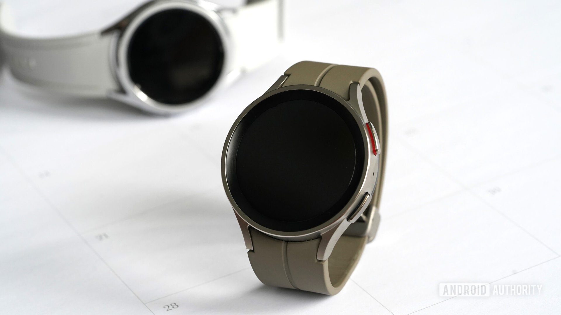 A Samsung Galaxy Watch 5 Pro rests with a Galaxy Watch 6 Classic in the background.