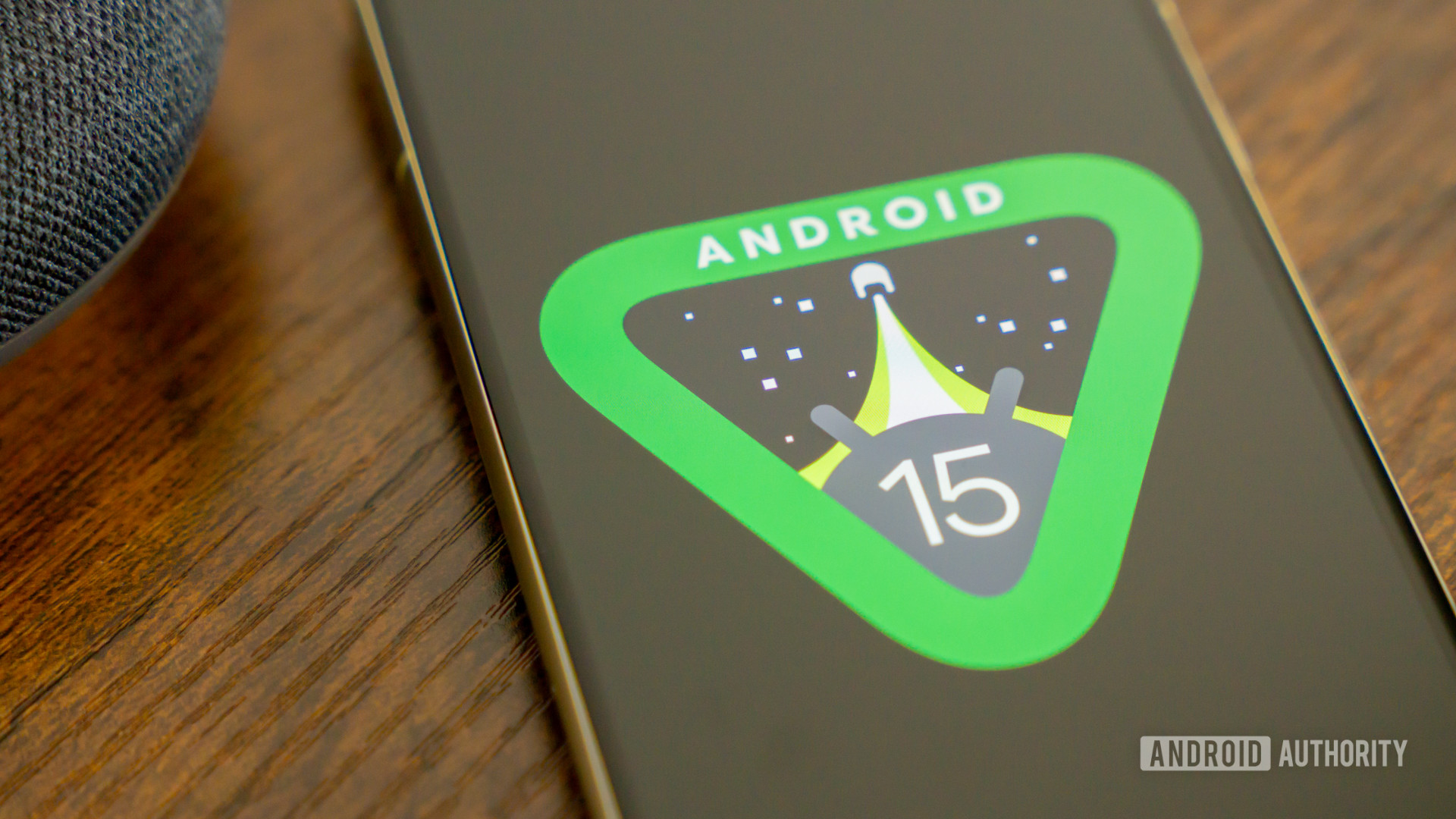 Android 15 logo on smartphone on bedside table stock photo (23)