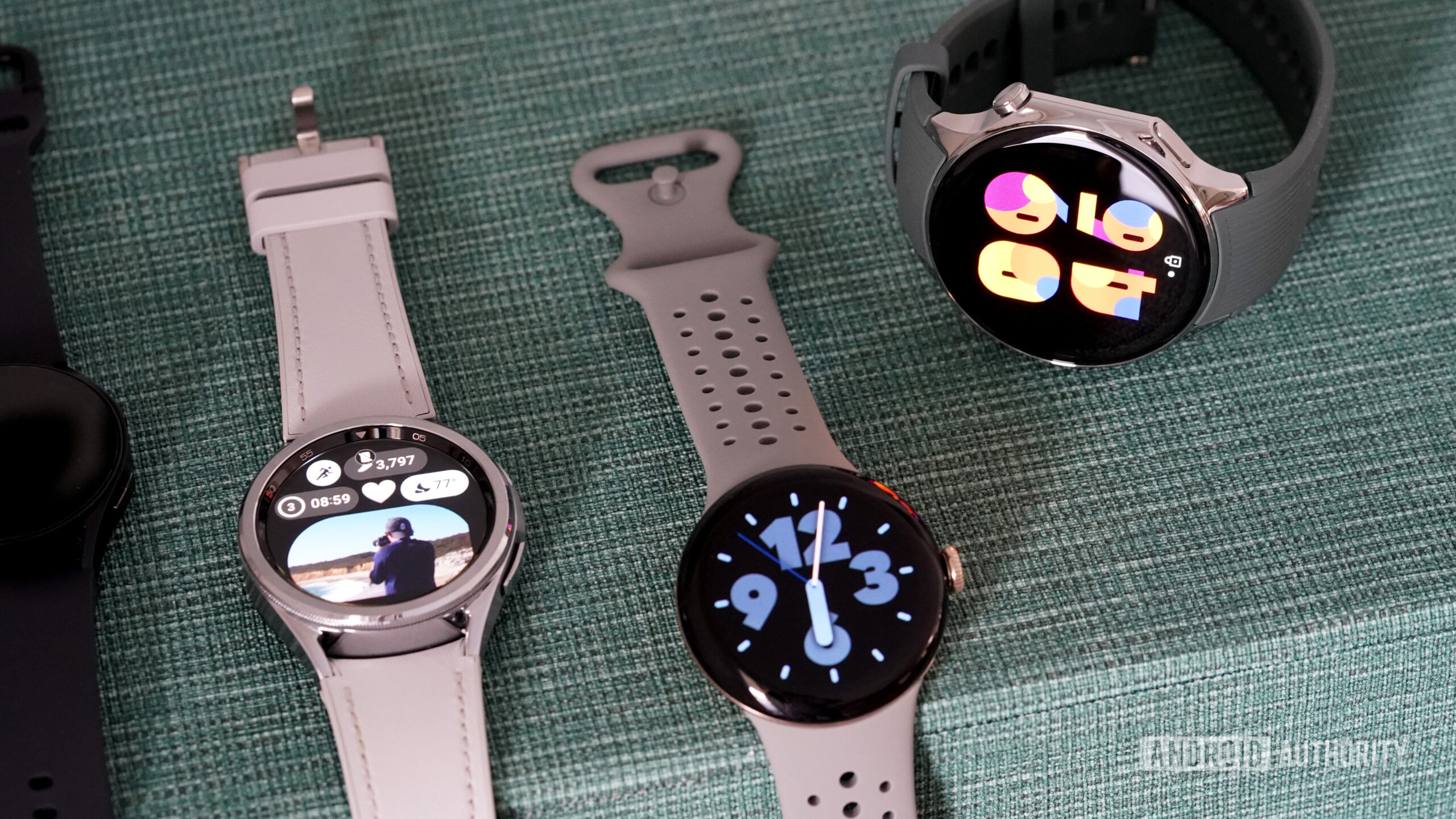 A OnePlus Watch 2 rests alongside alternative Wear OS devices.