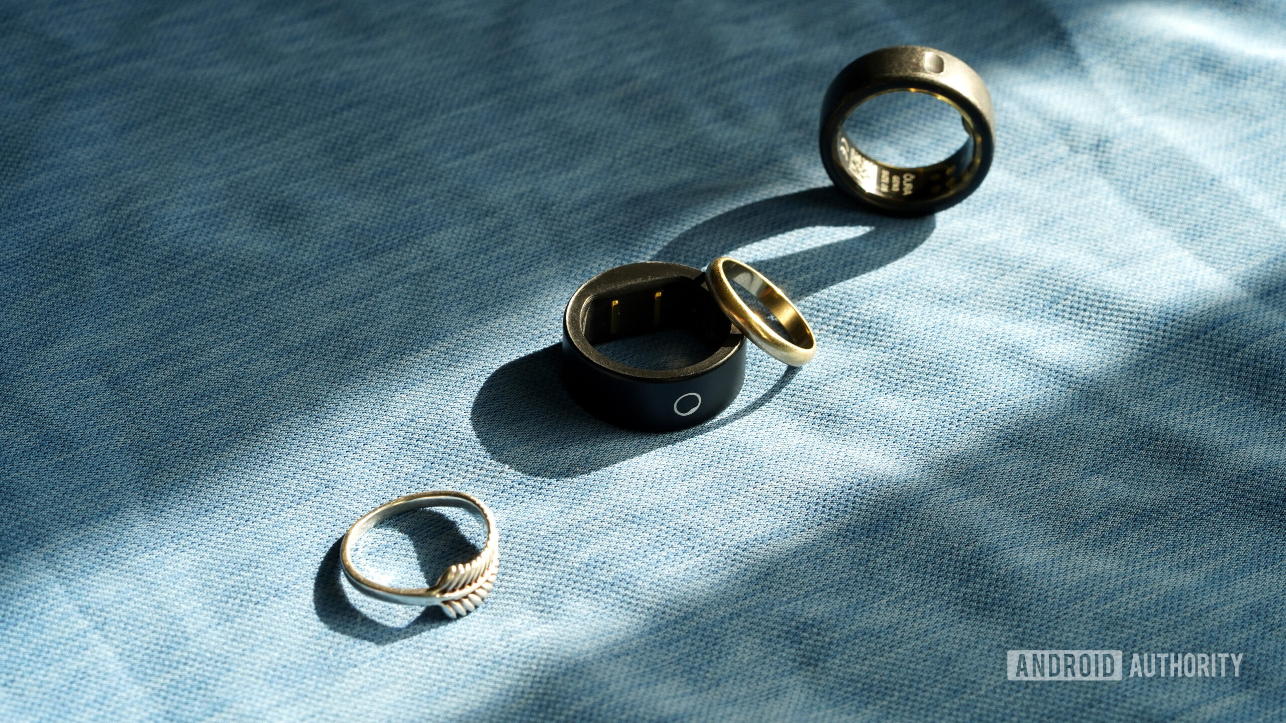 A Circular Ring Slim rests among a users jewelry and alternative smart ring.
