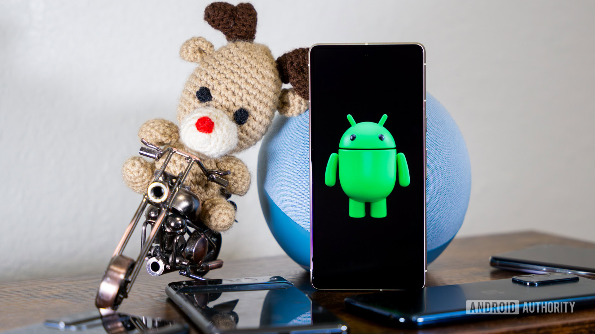 Android robot on smartphone next to other devices and accessories (1)